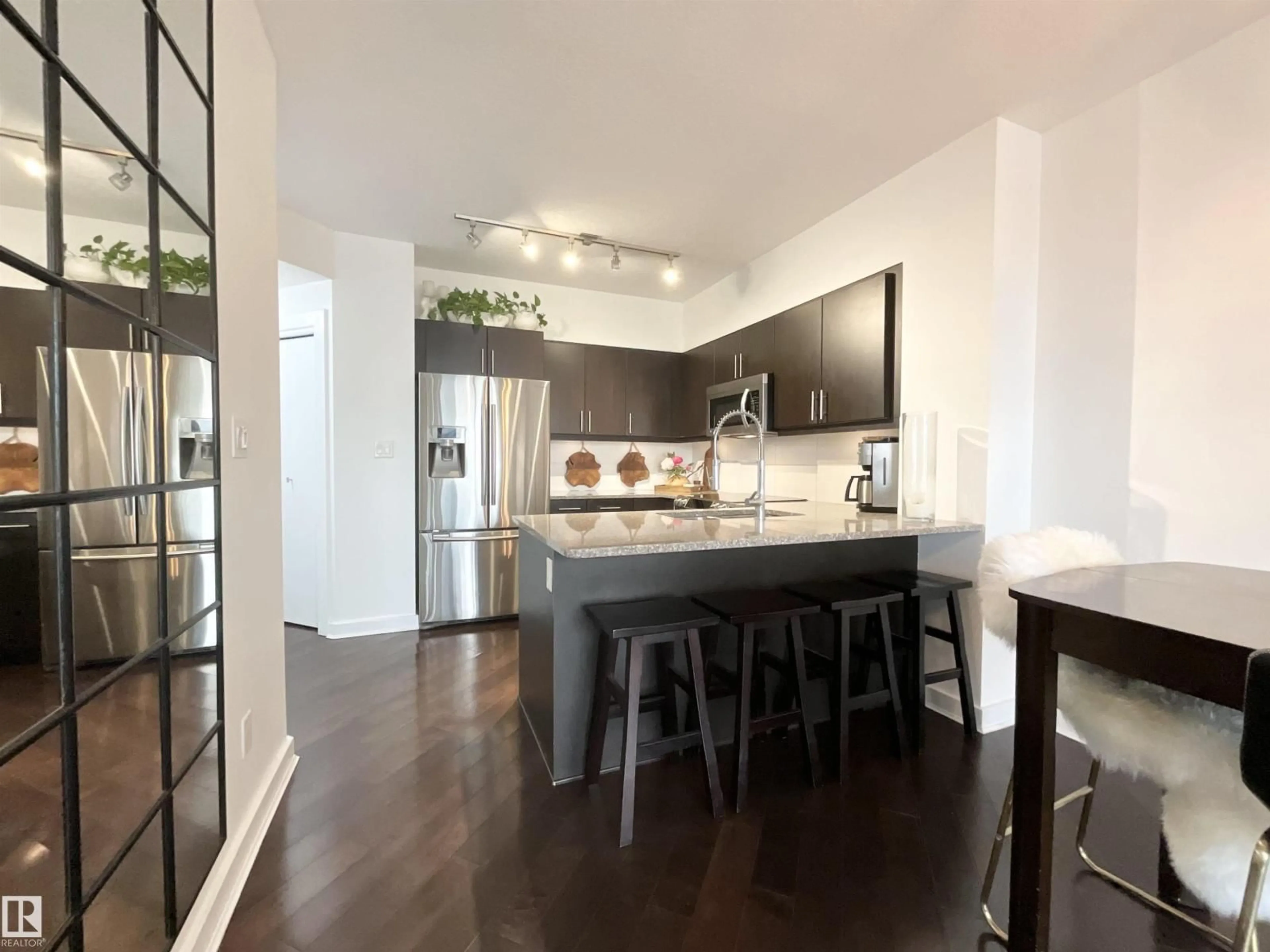 Open concept kitchen, wood/laminate floor for 1504 104 ST NW, Edmonton Alberta T5J0B6