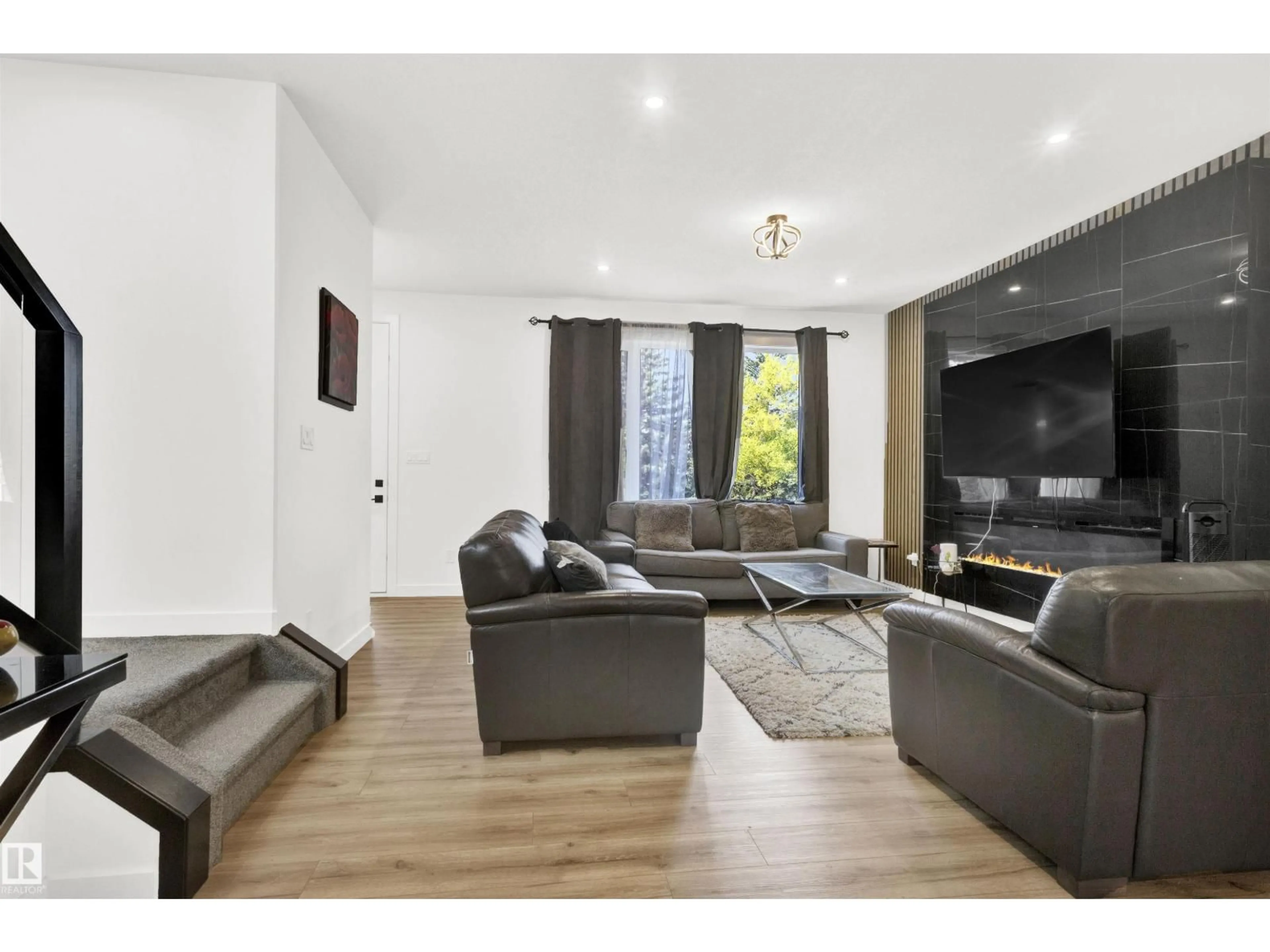 Living room with furniture, wood/laminate floor for NW - 9559 85 ST, Edmonton Alberta T6C3E1