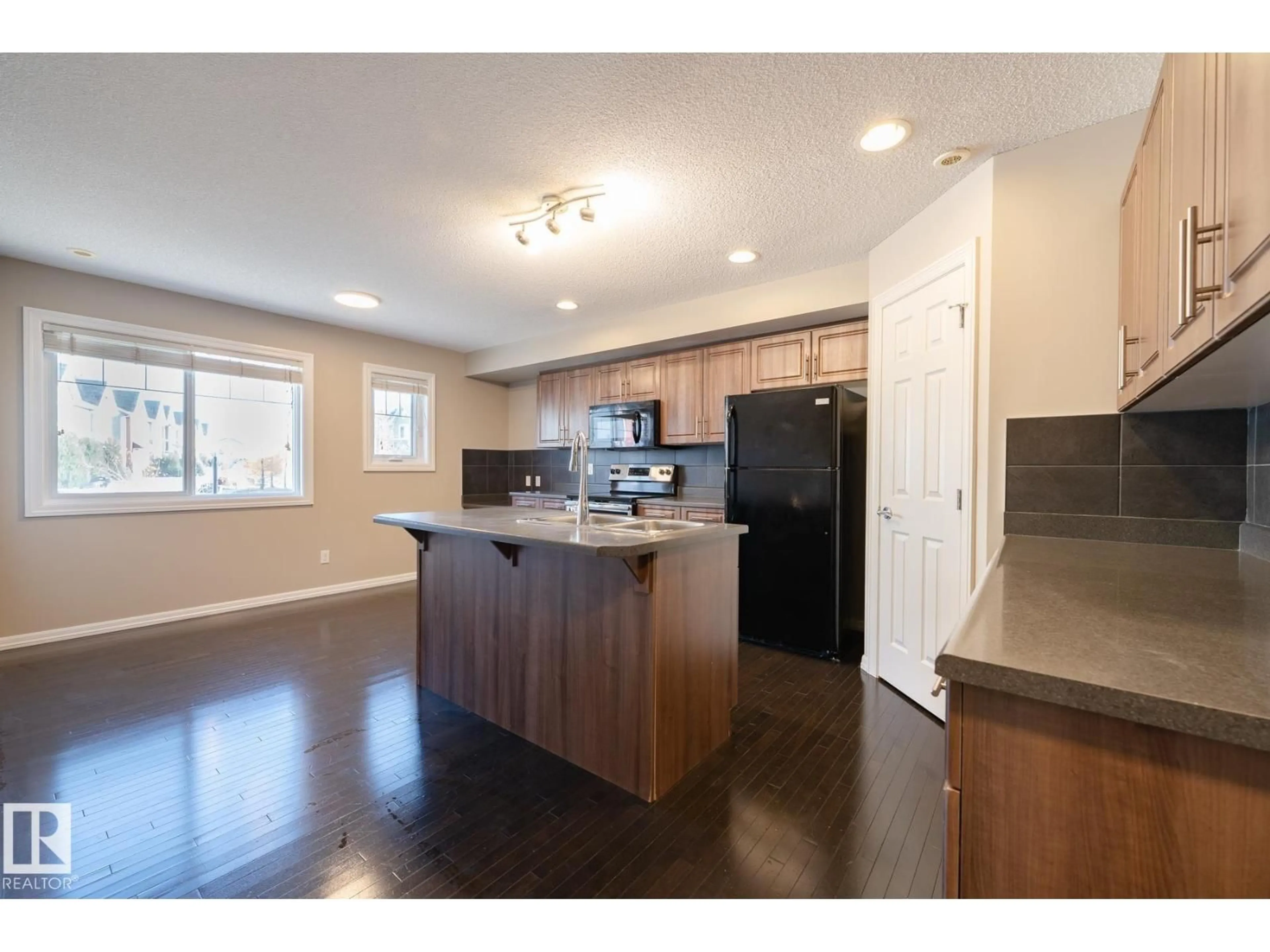 Open concept kitchen, wood/laminate floor for #103 - 655 TAMARACK RD, Edmonton Alberta T6T0N4