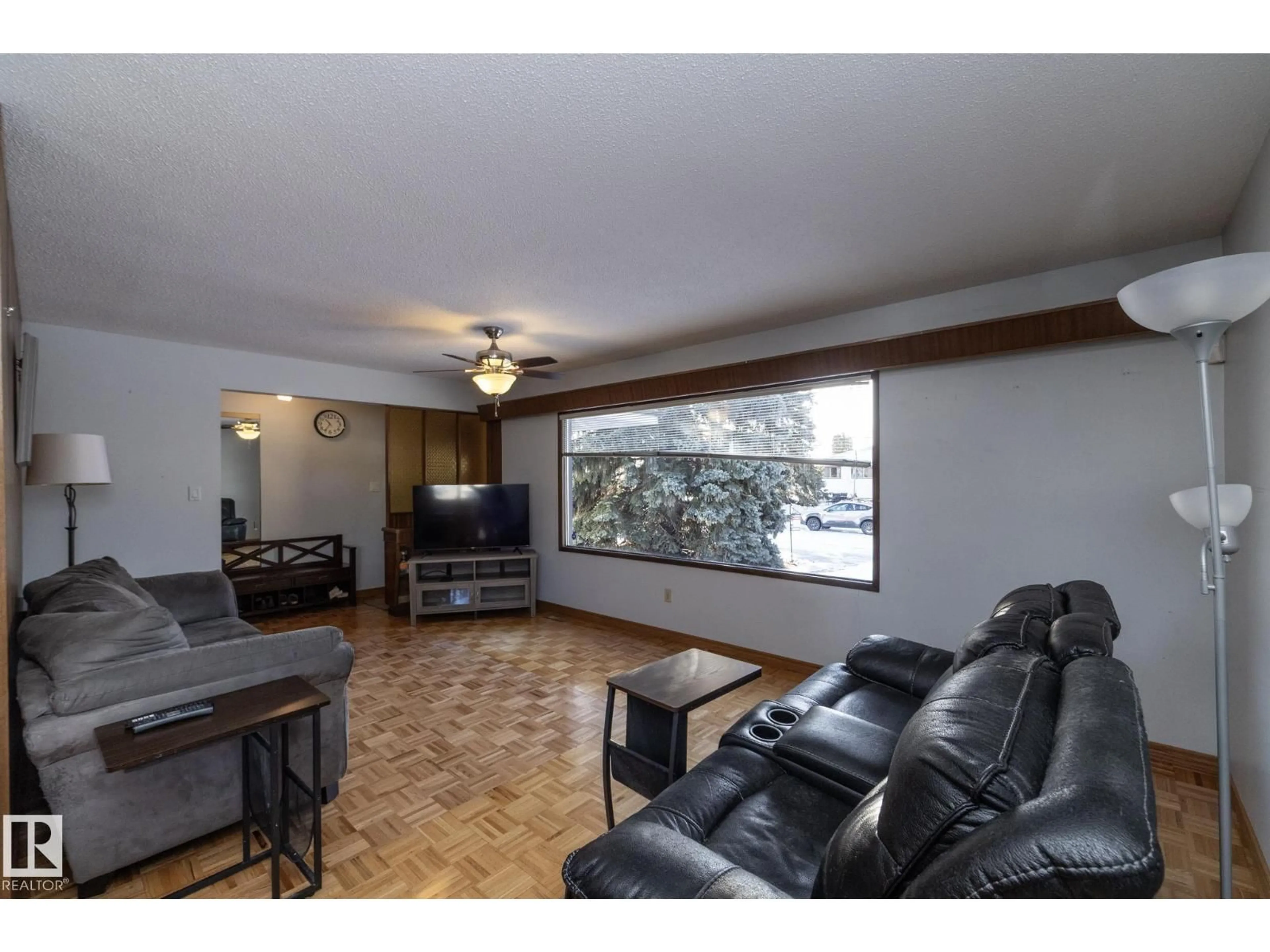Living room with furniture, wood/laminate floor for NW - 9020 152 AV, Edmonton Alberta T5E2R7
