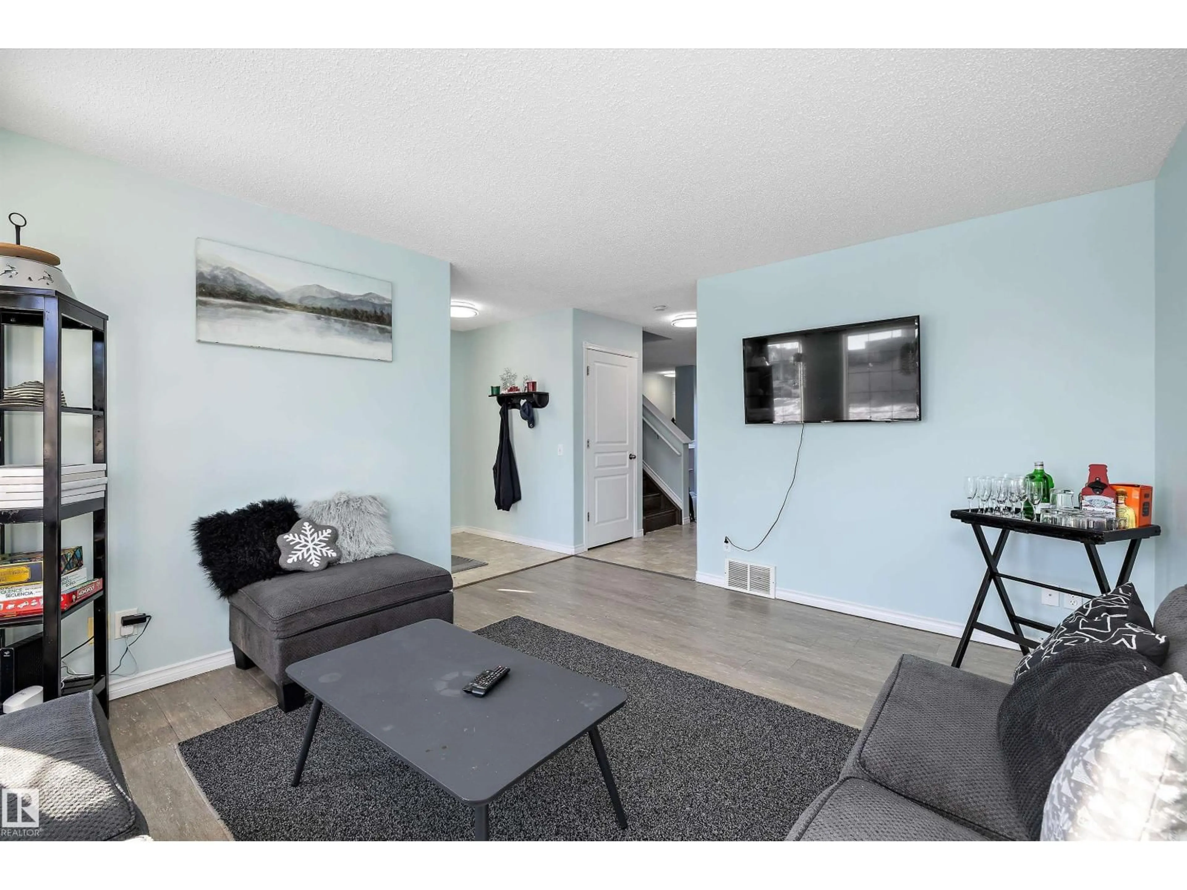 Living room with furniture, wood/laminate floor for 16304 43 ST, Edmonton Alberta T5Y0H8