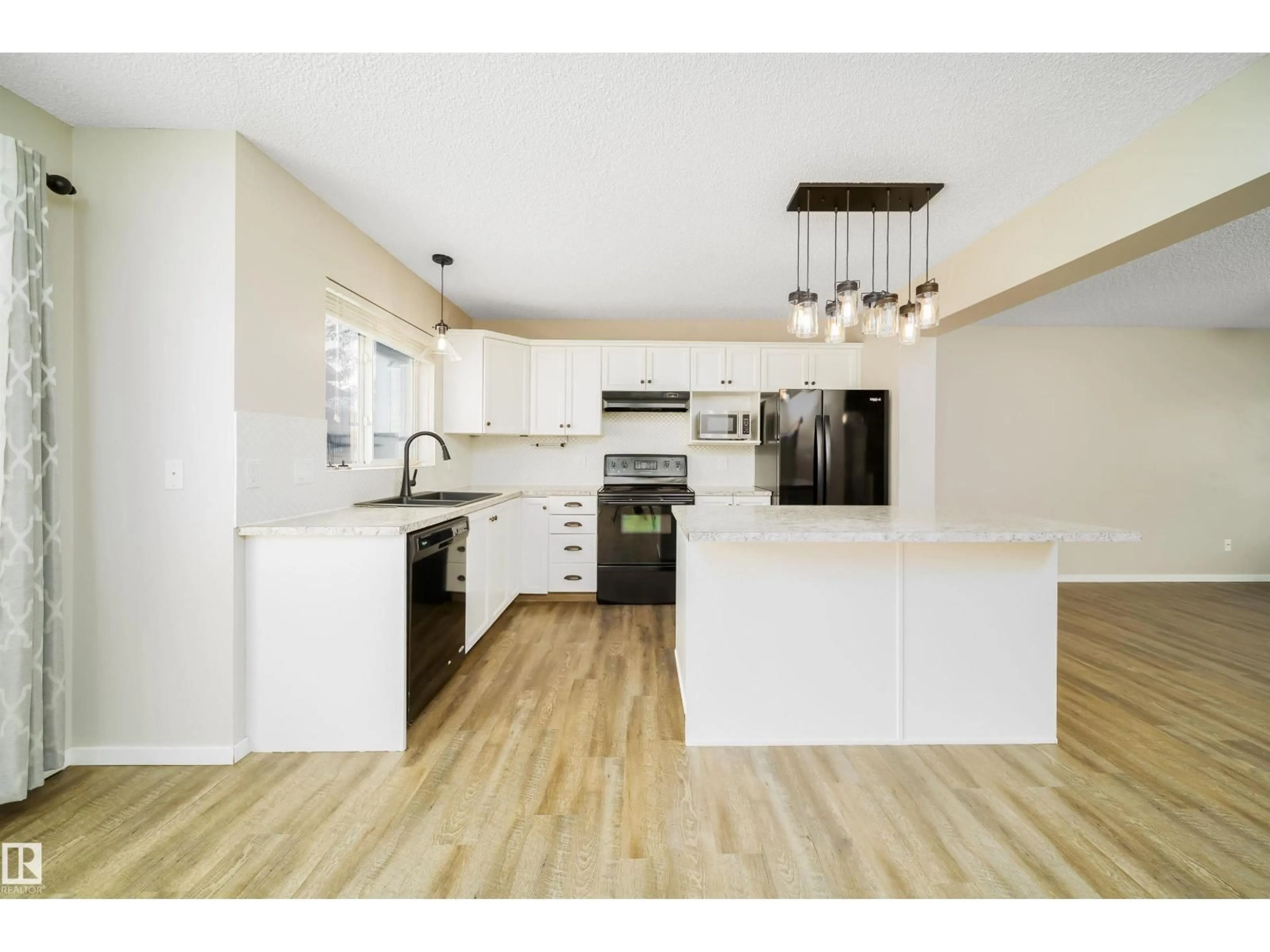Open concept kitchen, wood/laminate floor for 1695 TOMPKINS PL, Edmonton Alberta T6R2Y4