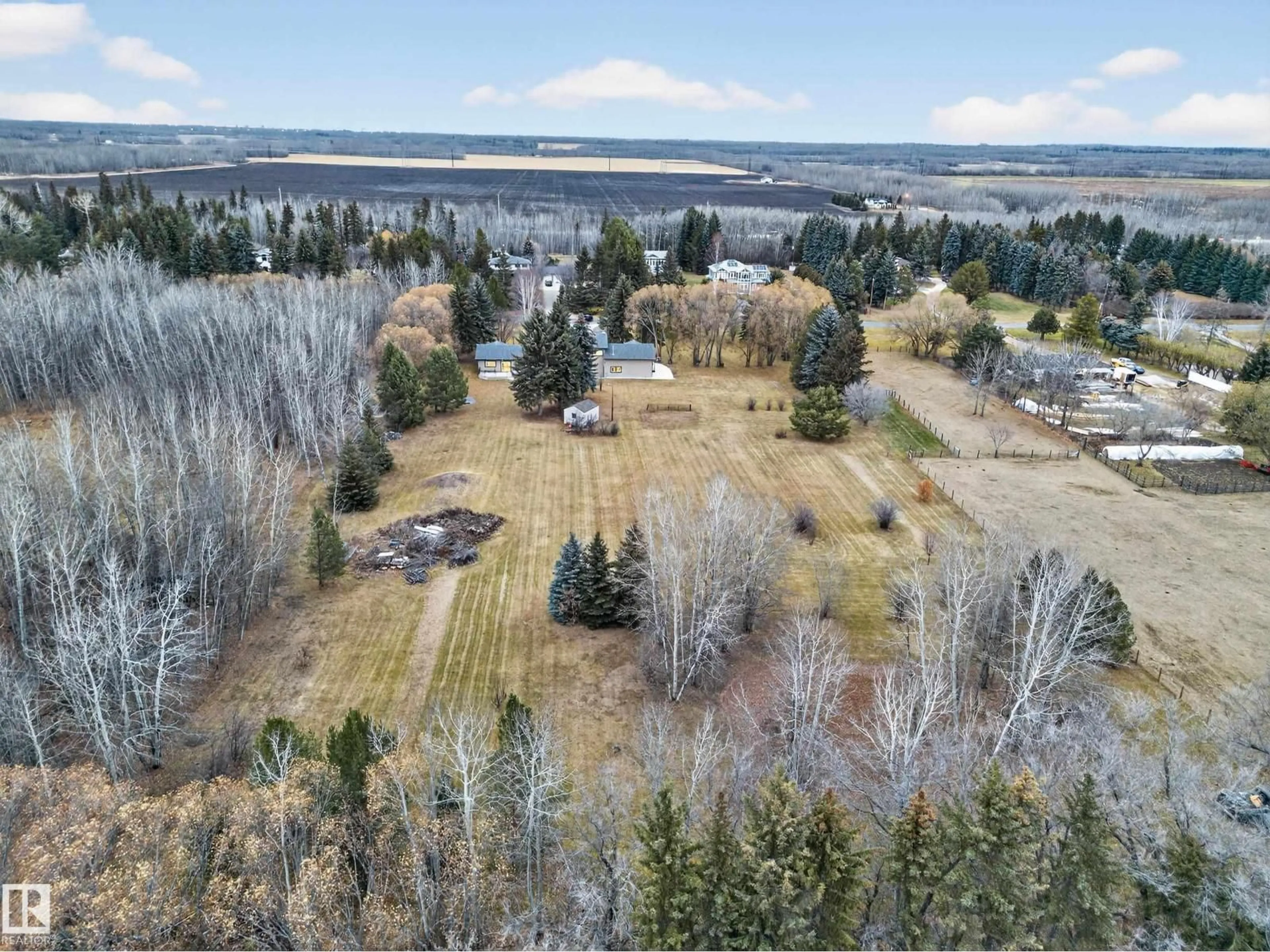 A pic from outside/outdoor area/front of a property/back of a property/a pic from drone, forest/trees view for 37 - 51528 RGE ROAD 262, Rural Parkland County Alberta T6Y1C1