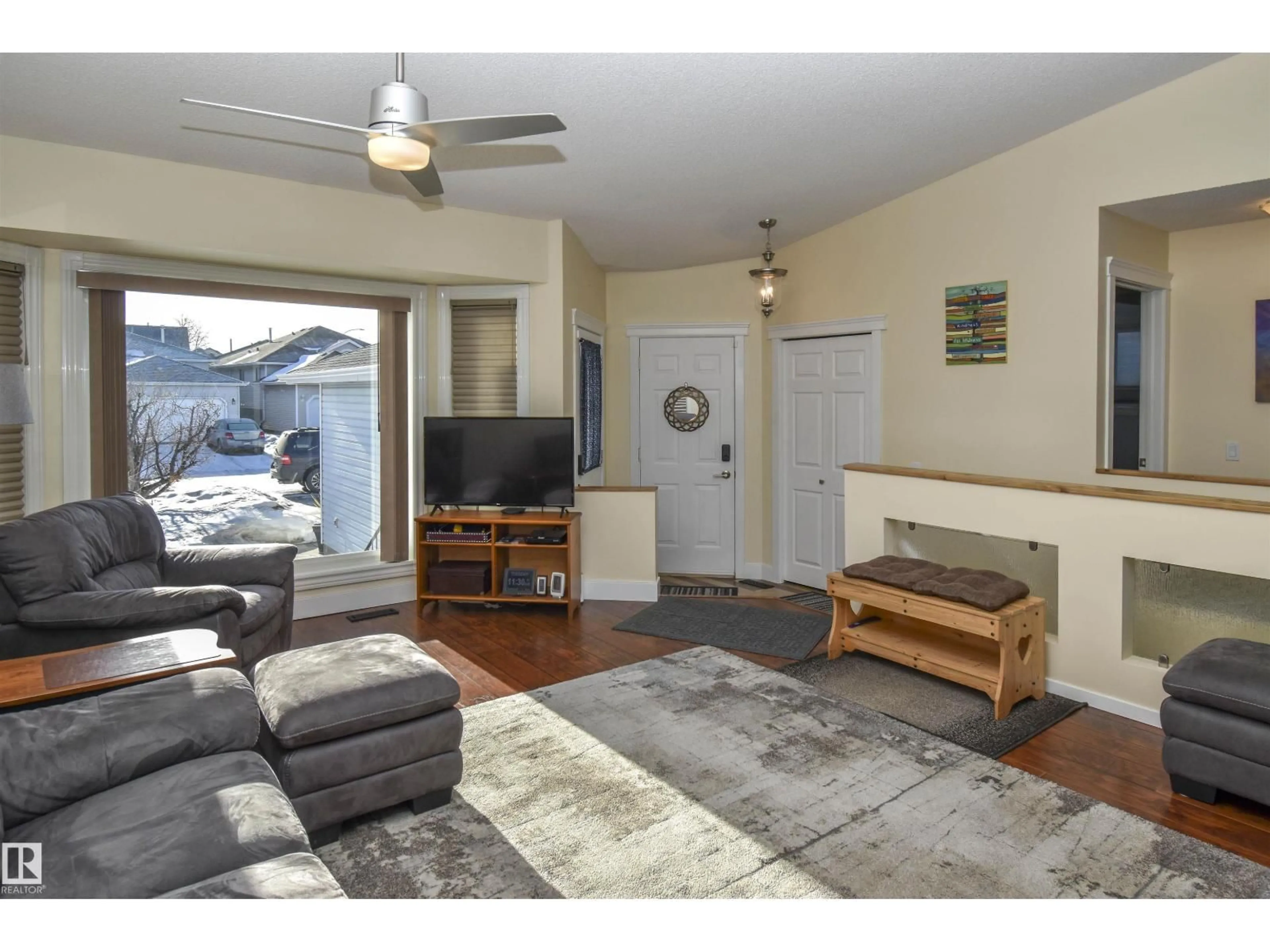 Living room with furniture, wood/laminate floor for 4042 37A AV NW, Edmonton Alberta T6L7A1