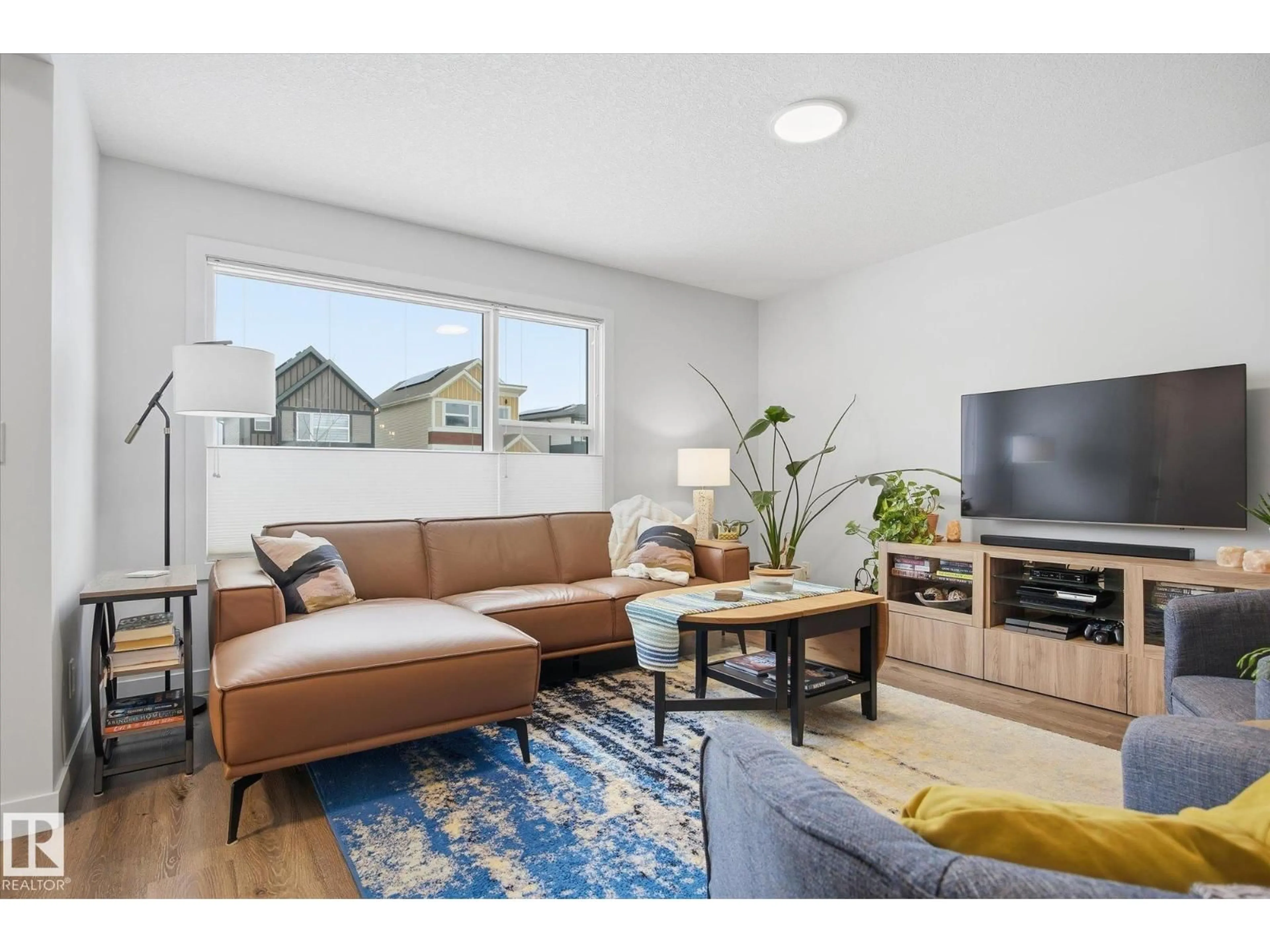 Living room with furniture, wood/laminate floor for 201 CHARLESWORTH DR, Edmonton Alberta T6X2W2