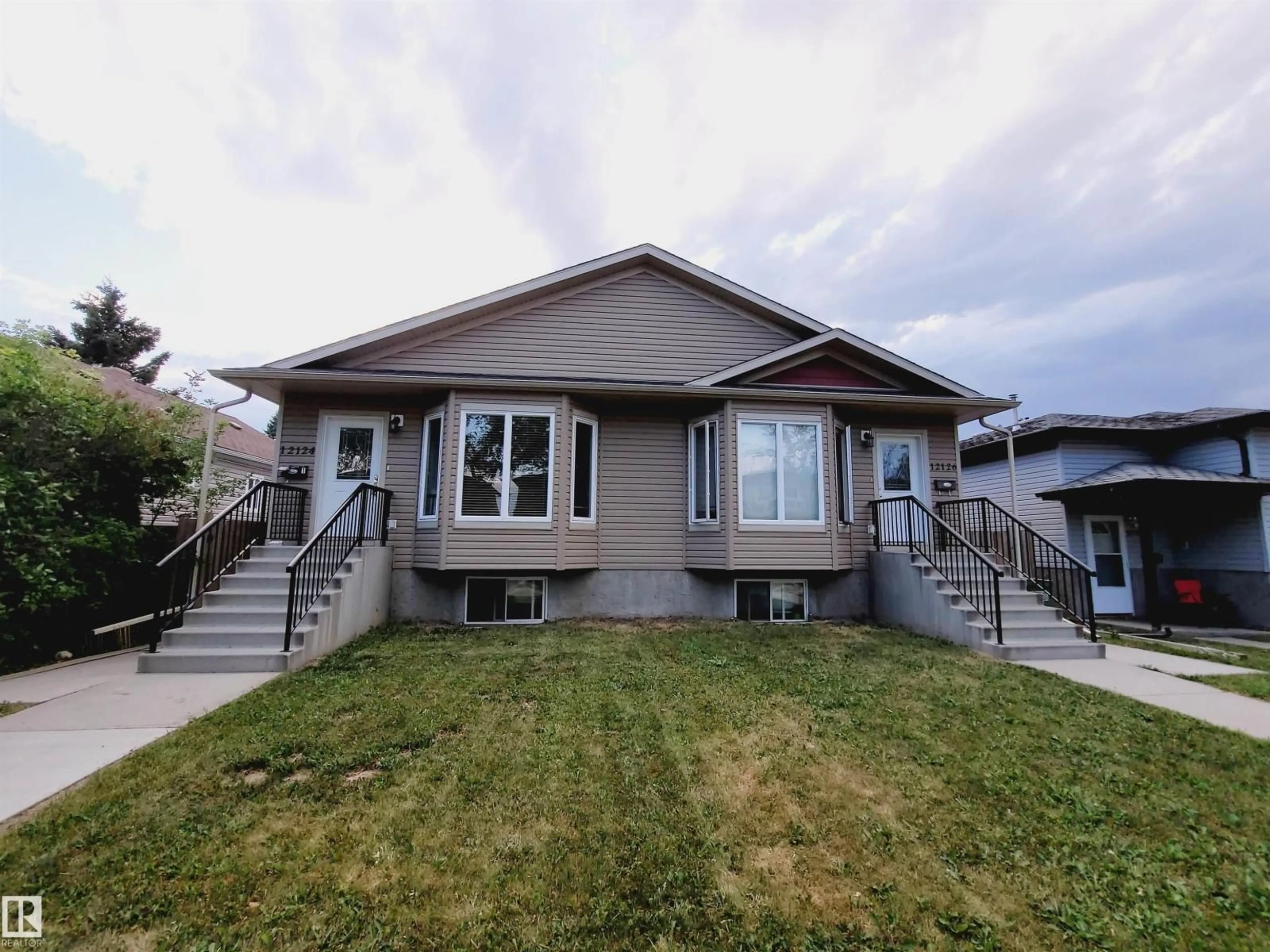 Home with vinyl exterior material, street for 12124 122 ST, Edmonton Alberta T5L0C8