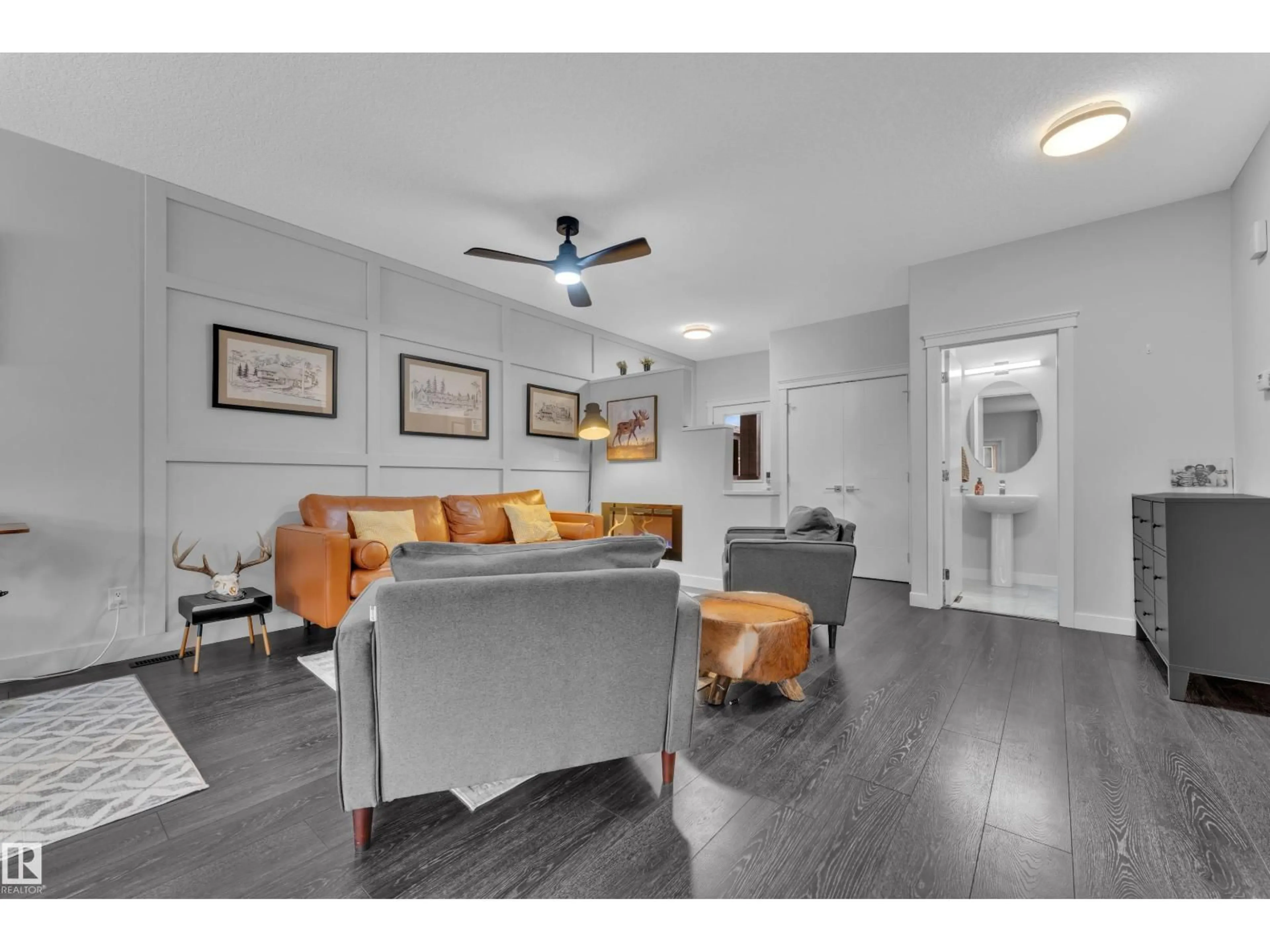 Living room with furniture, wood/laminate floor for 906 BERG PL, Leduc Alberta T9E1H2