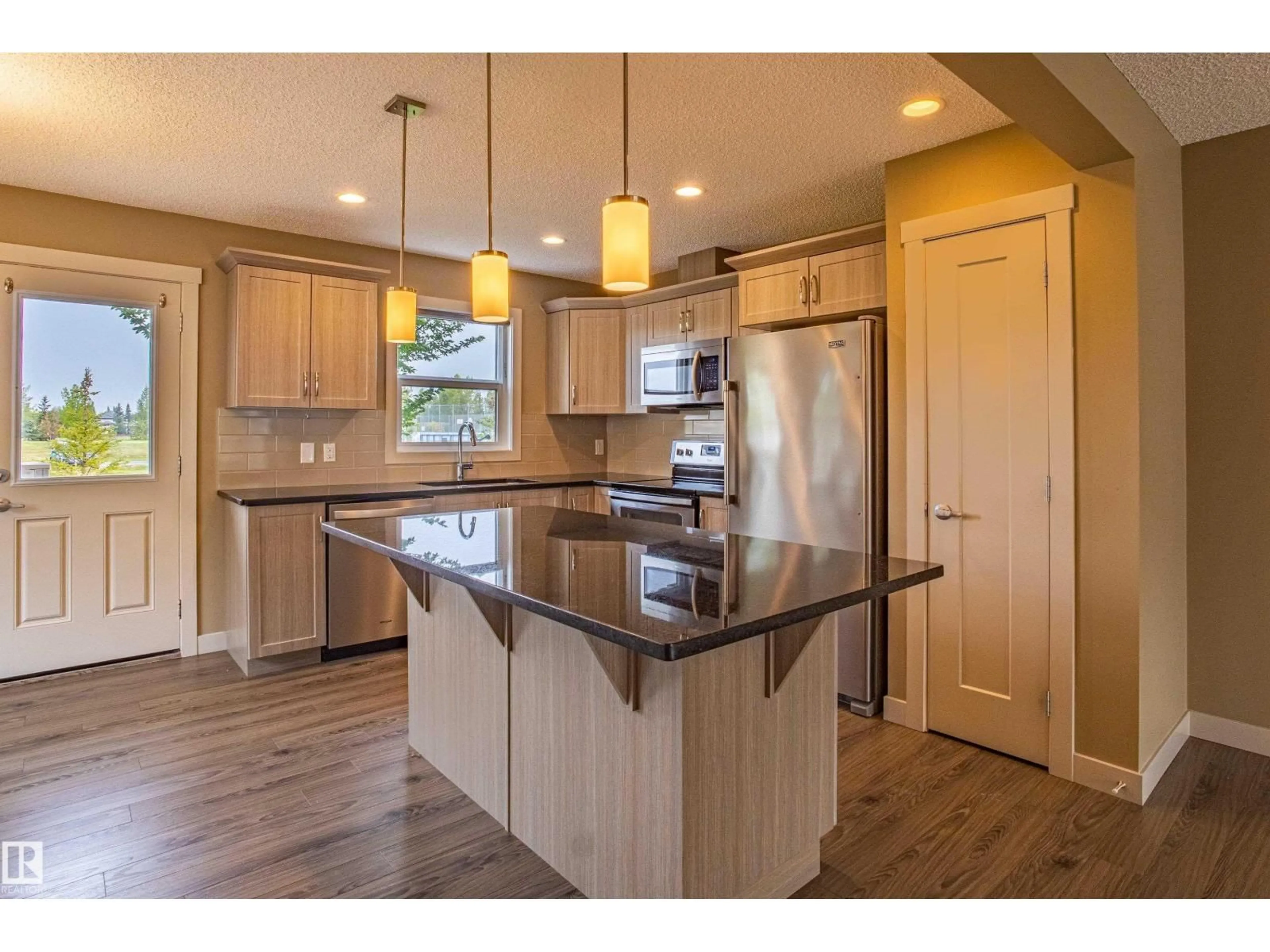 Open concept kitchen, wood/laminate floor for #32 - 2121 HADDOW DR, Edmonton Alberta T6R0W6