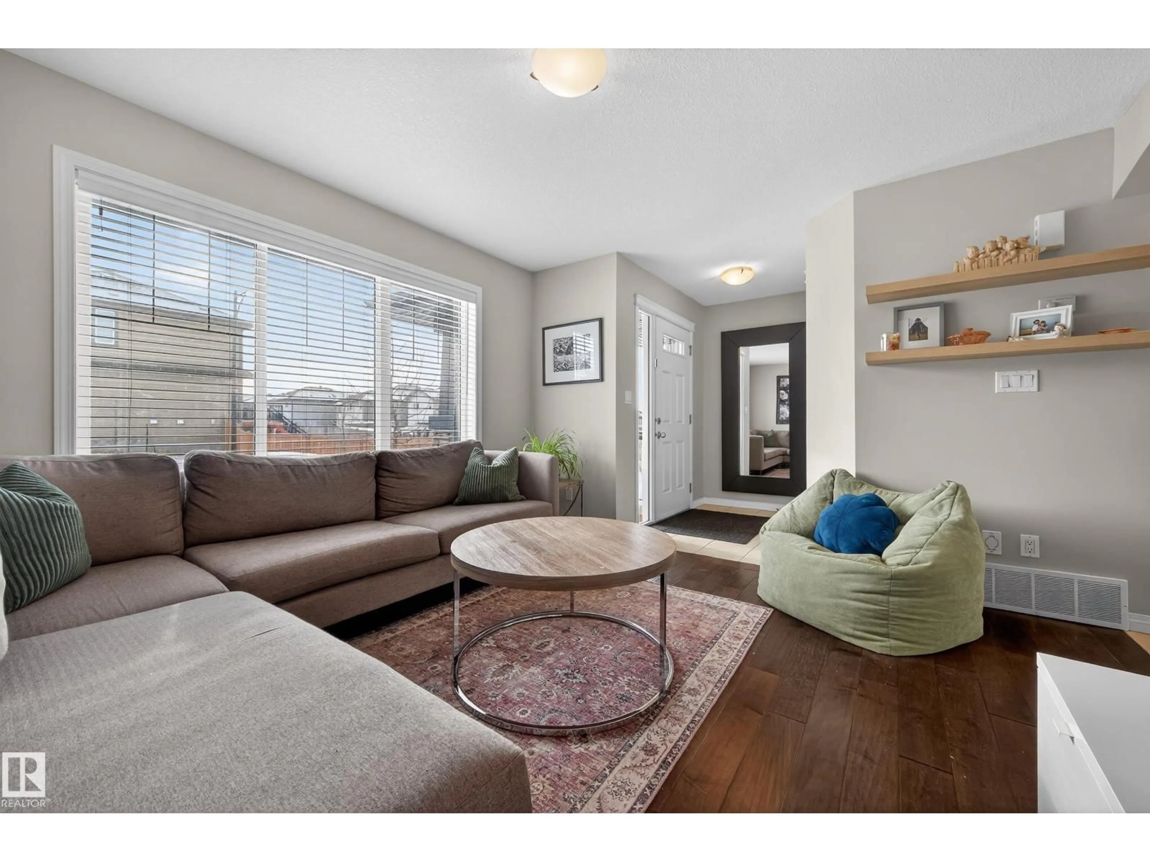 Living room with furniture, wood/laminate floor for 5256 21 AV, Edmonton Alberta T6X1X3