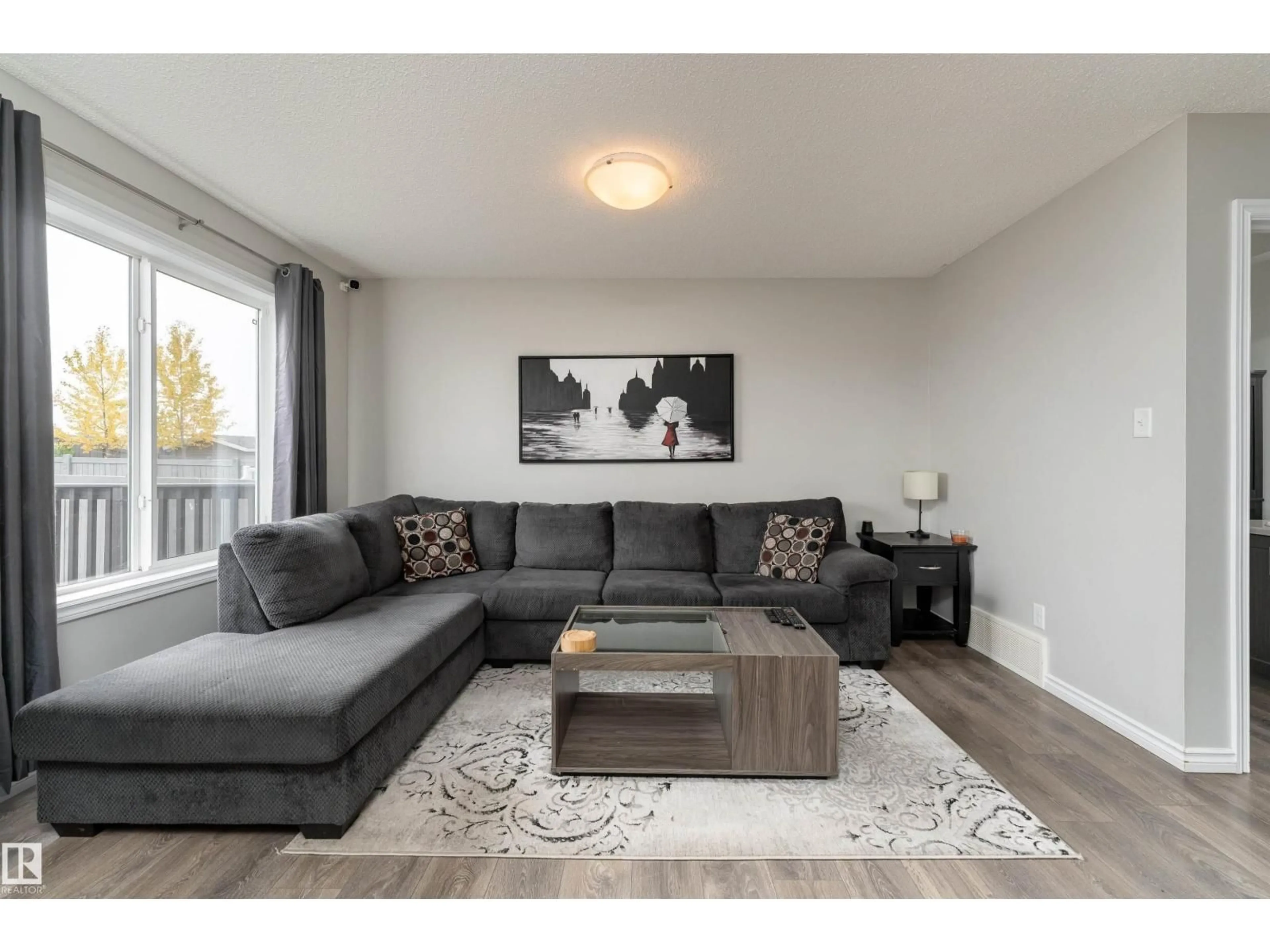 Living room with furniture, wood/laminate floor for 521 EBBERS WY, Edmonton Alberta T5Y3T8