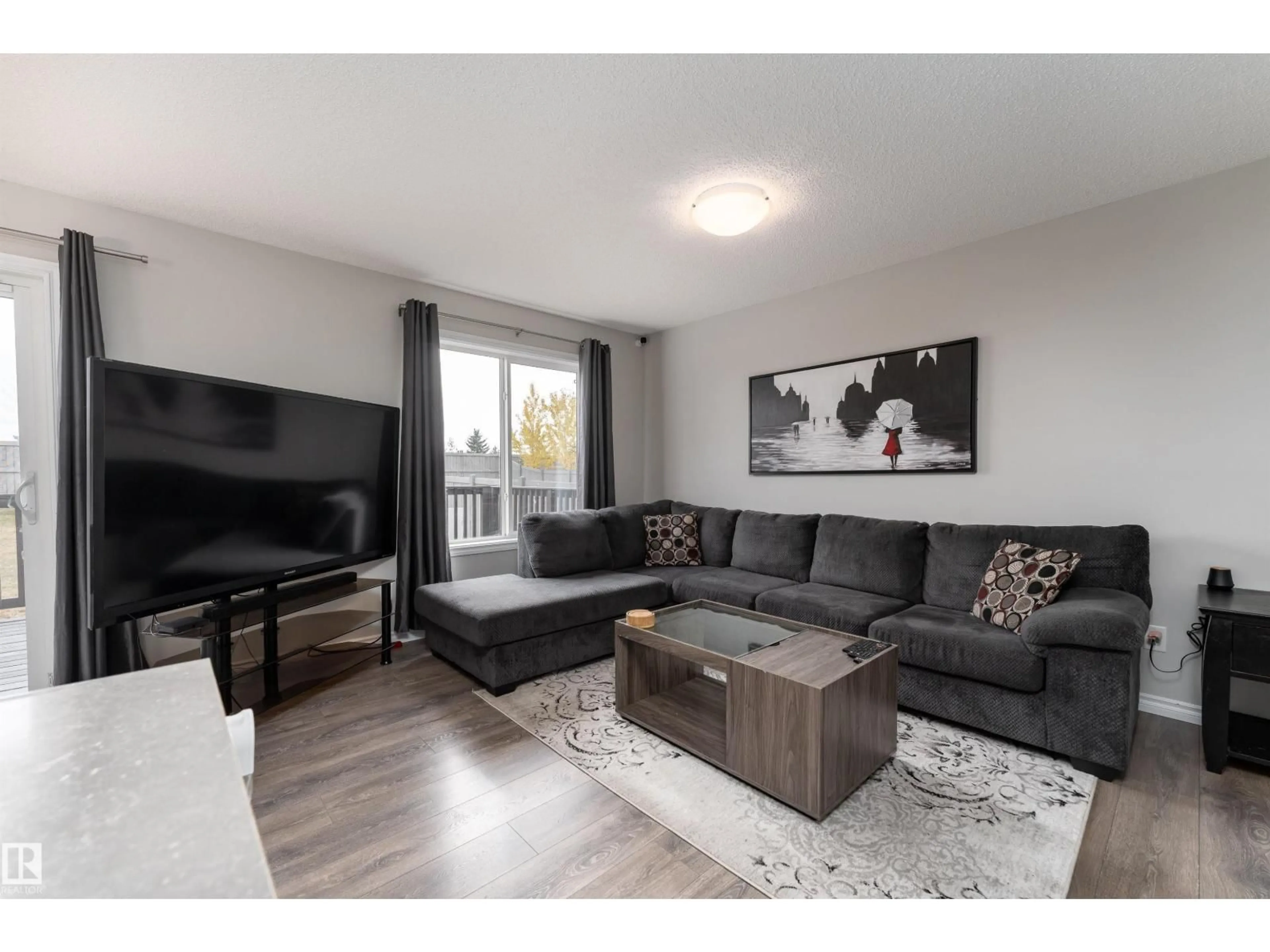 Living room with furniture, wood/laminate floor for 521 EBBERS WY, Edmonton Alberta T5Y3T8