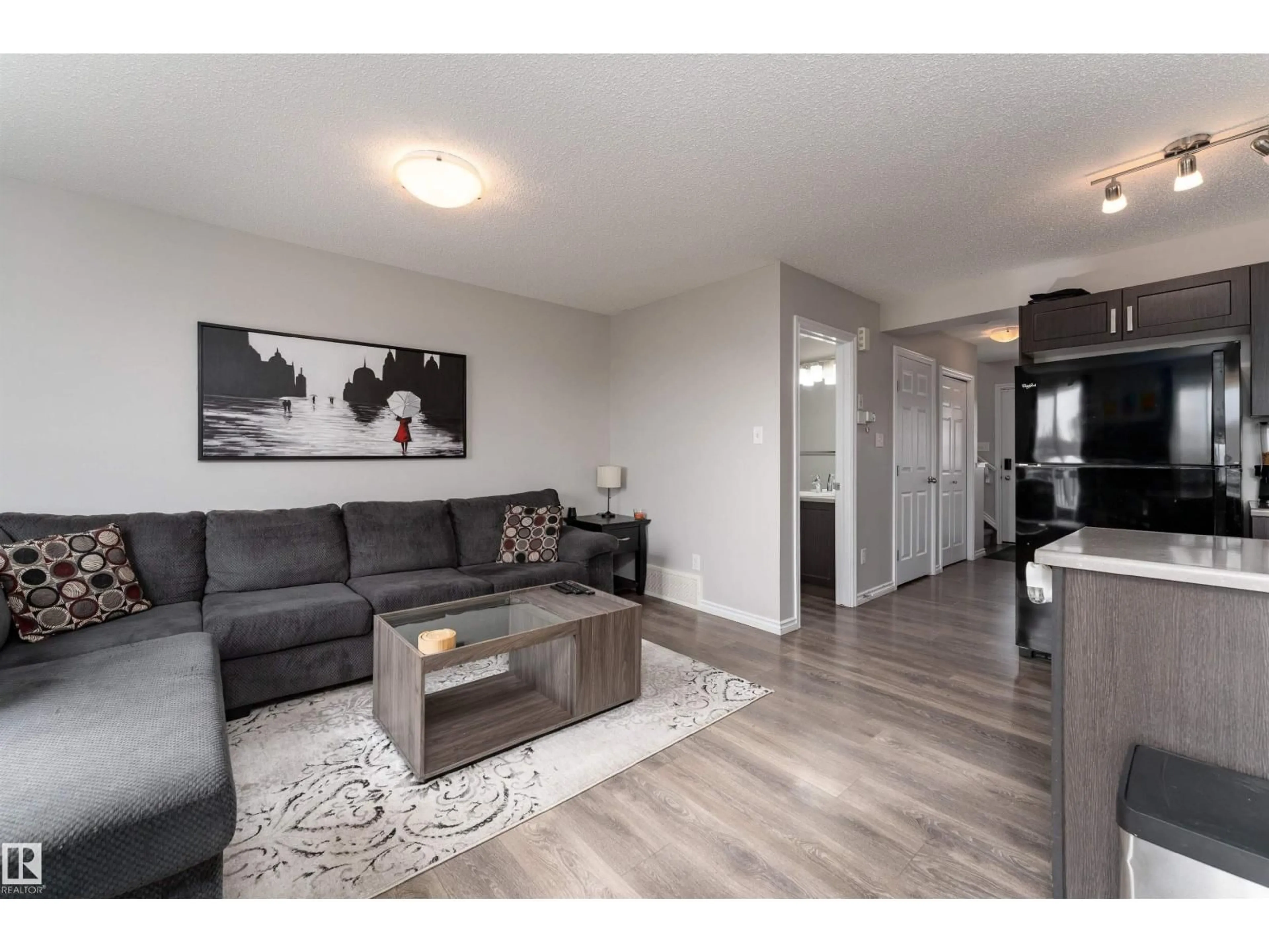 Living room with furniture, wood/laminate floor for 521 EBBERS WY, Edmonton Alberta T5Y3T8