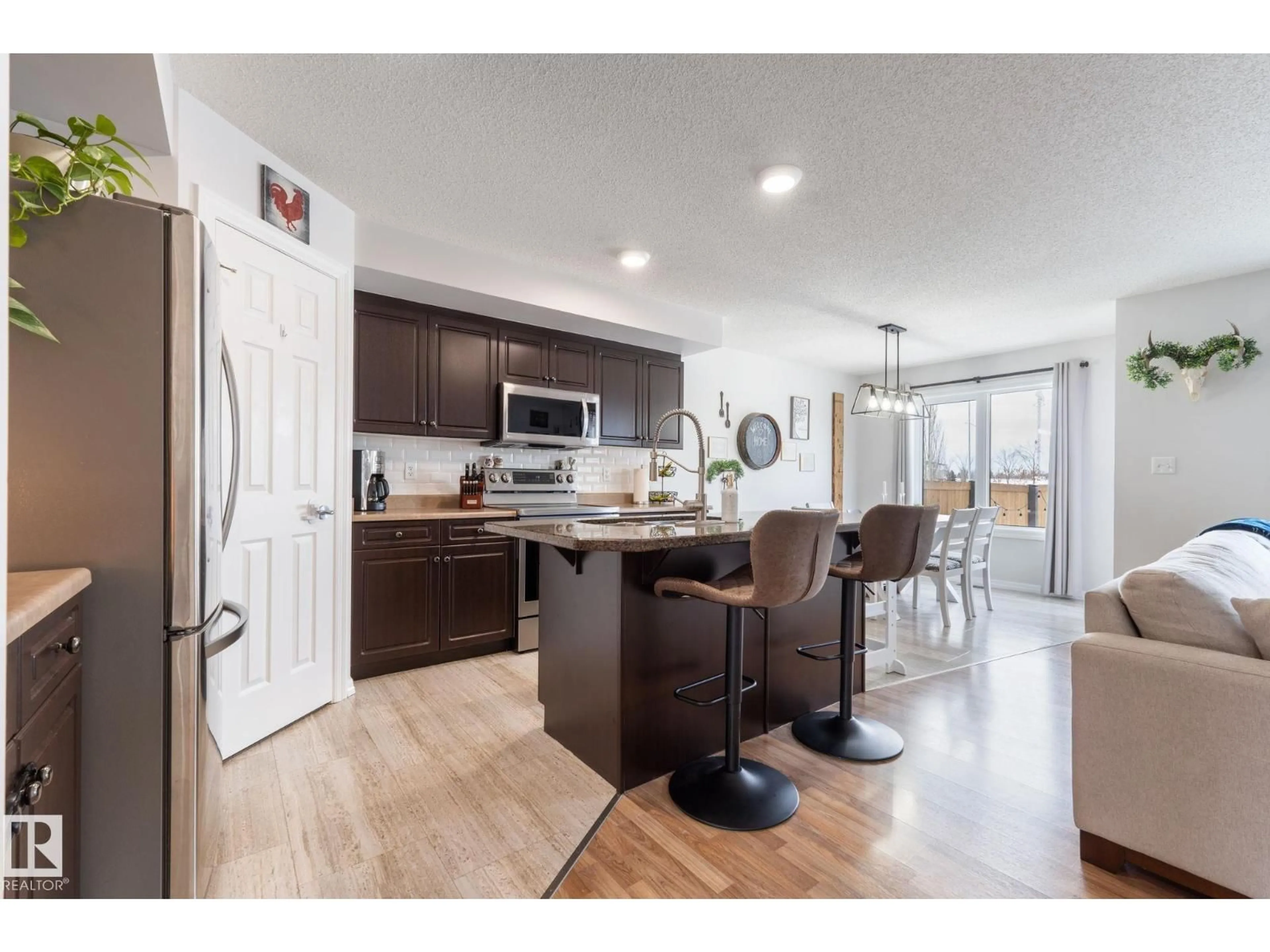 Open concept kitchen, wood/laminate floor for 66 CALVERT WD, Fort Saskatchewan Alberta T8L0C3