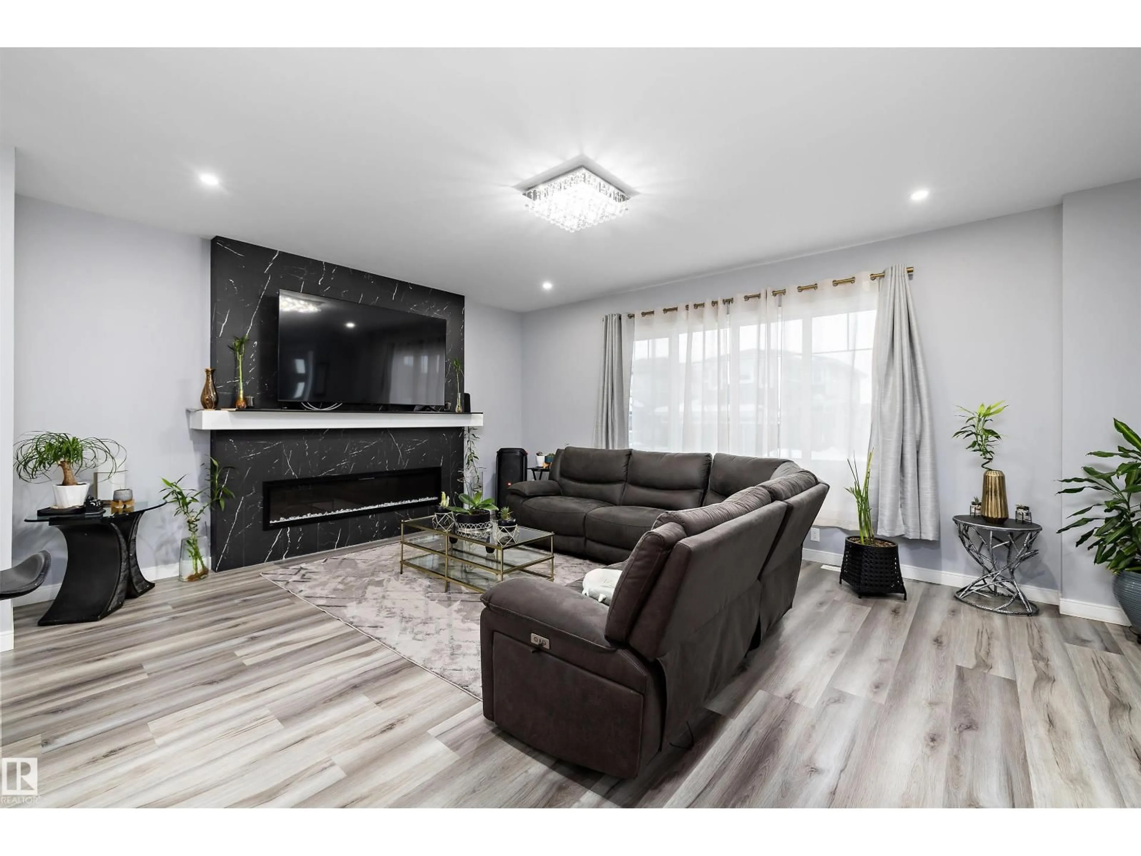 Living room with furniture, wood/laminate floor for 4223 VETERANS WY, Edmonton Alberta T5E6W7