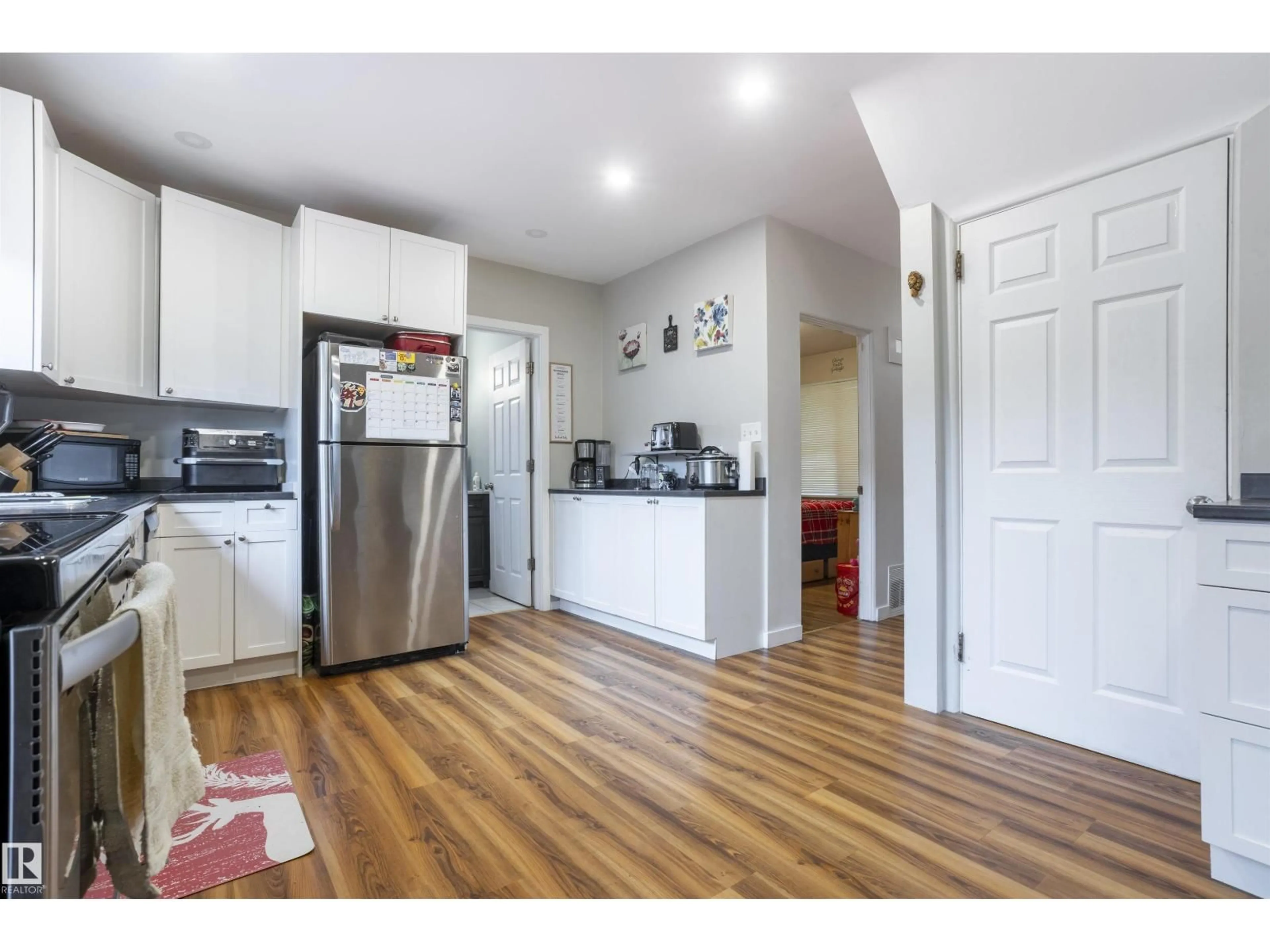 Open concept kitchen, wood/laminate floor for 10880 73 ST, Edmonton Alberta T5B1Y7