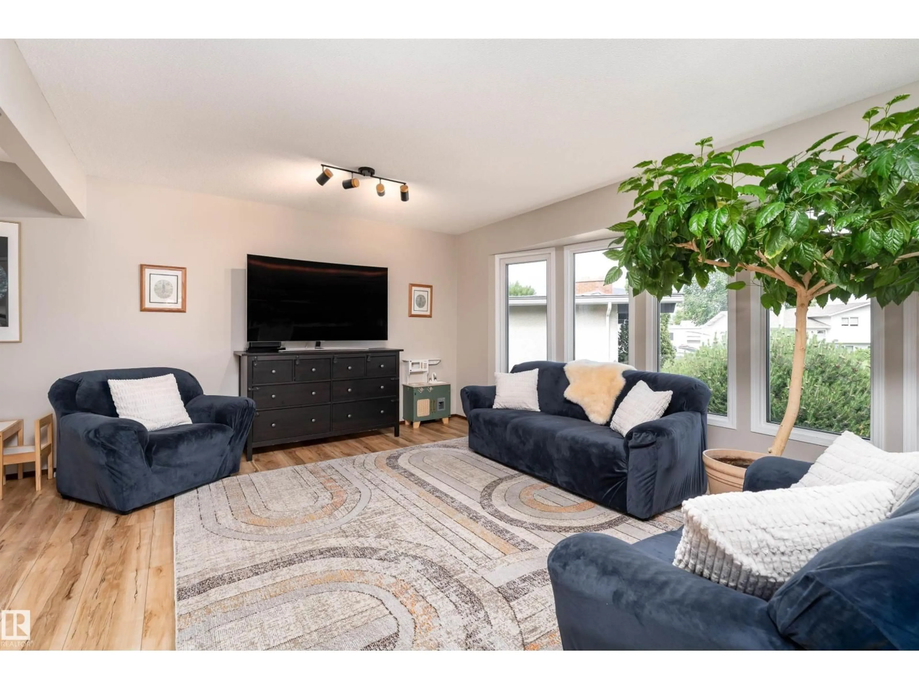 Living room with furniture, wood/laminate floor for 15007 115 ST, Edmonton Alberta T5X1H9