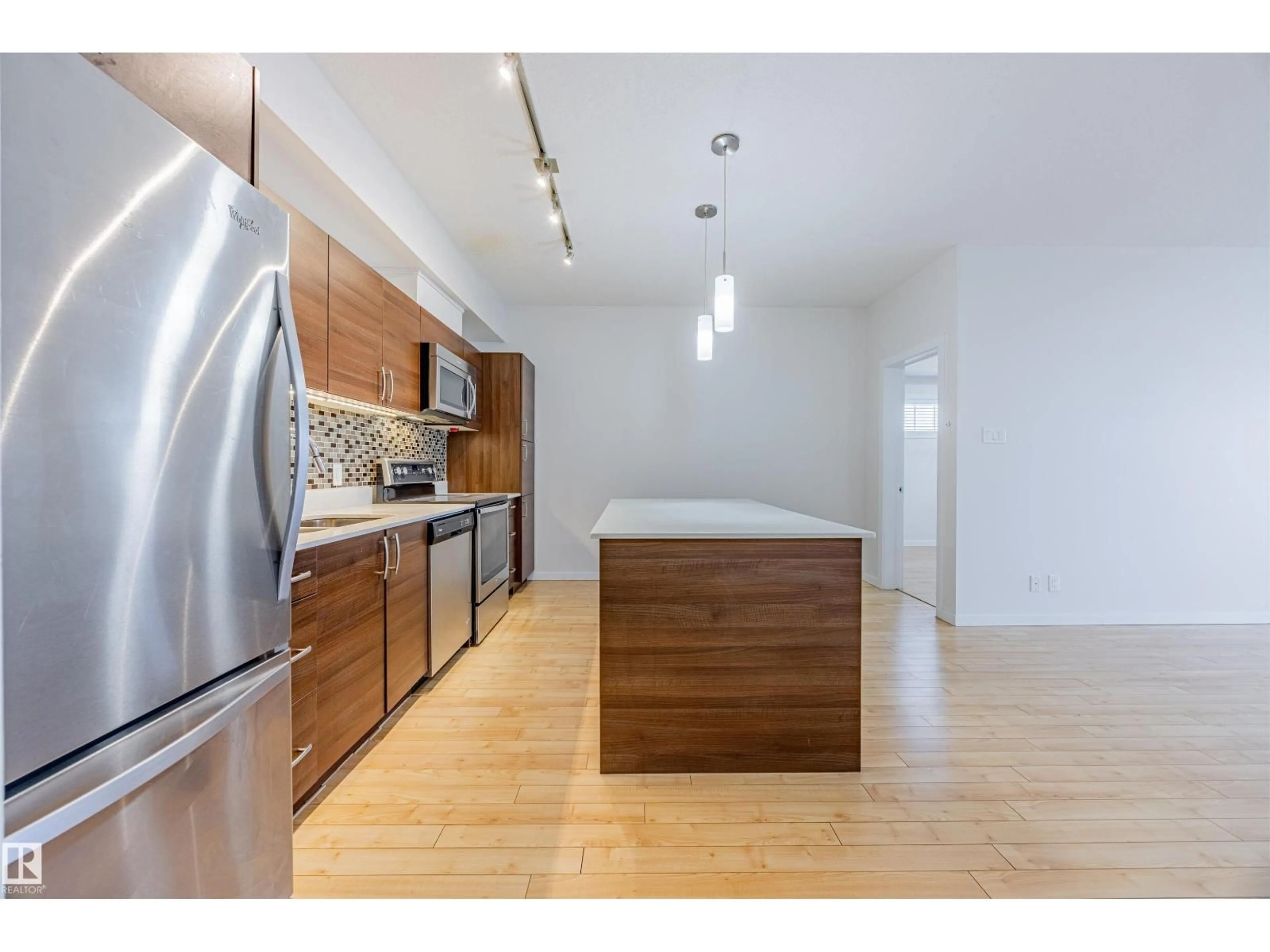 Open concept kitchen, wood/laminate floor for #409 - 9517 160 AV, Edmonton Alberta T5Z0N1