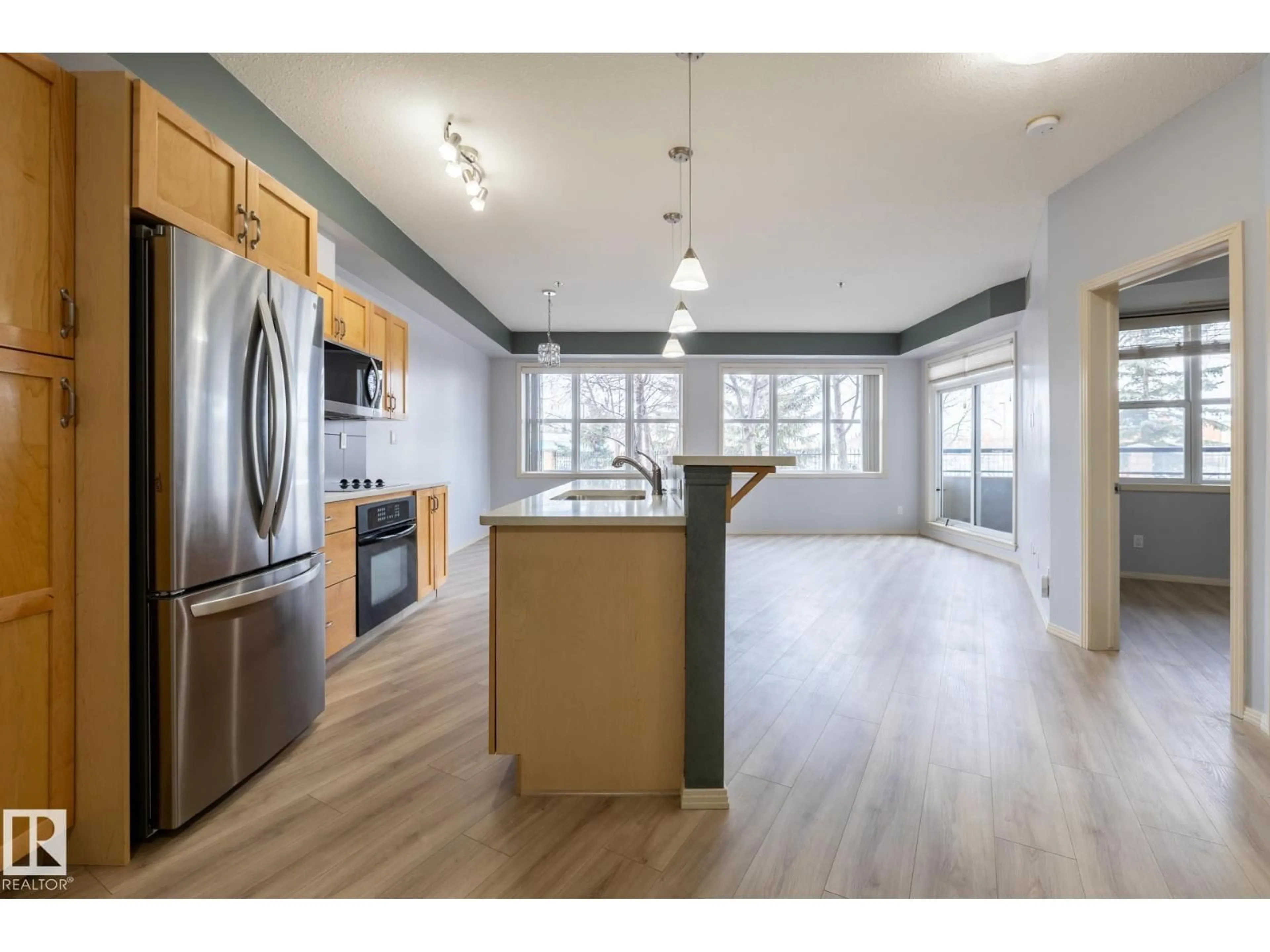 Open concept kitchen, wood/laminate floor for #102 - 4835 104A ST, Edmonton Alberta T6H0R5