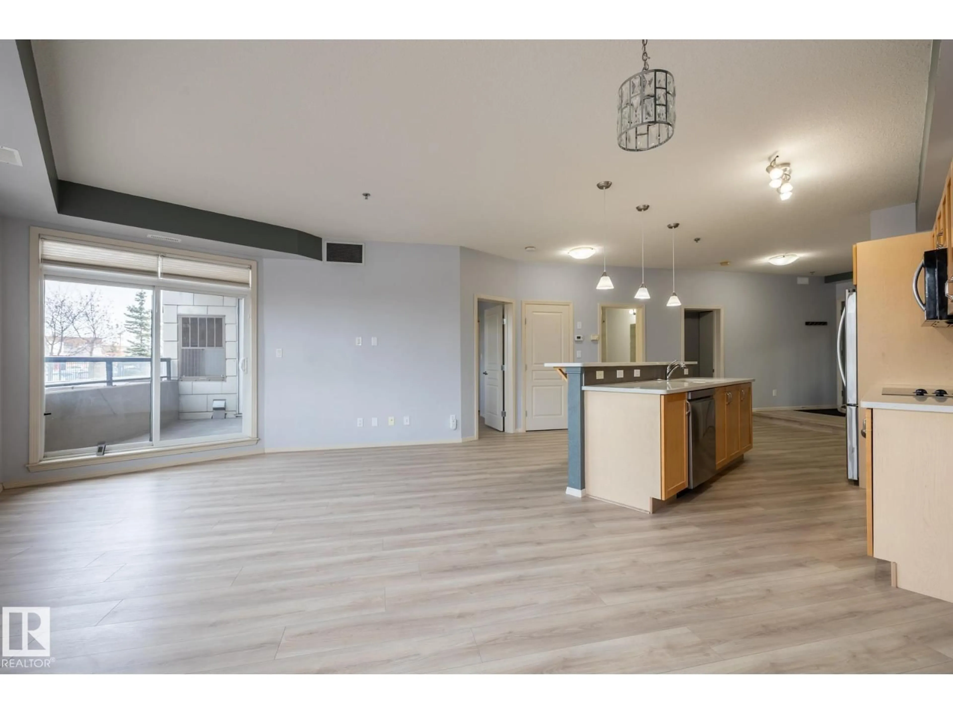 Open concept kitchen, wood/laminate floor for #102 - 4835 104A ST, Edmonton Alberta T6H0R5