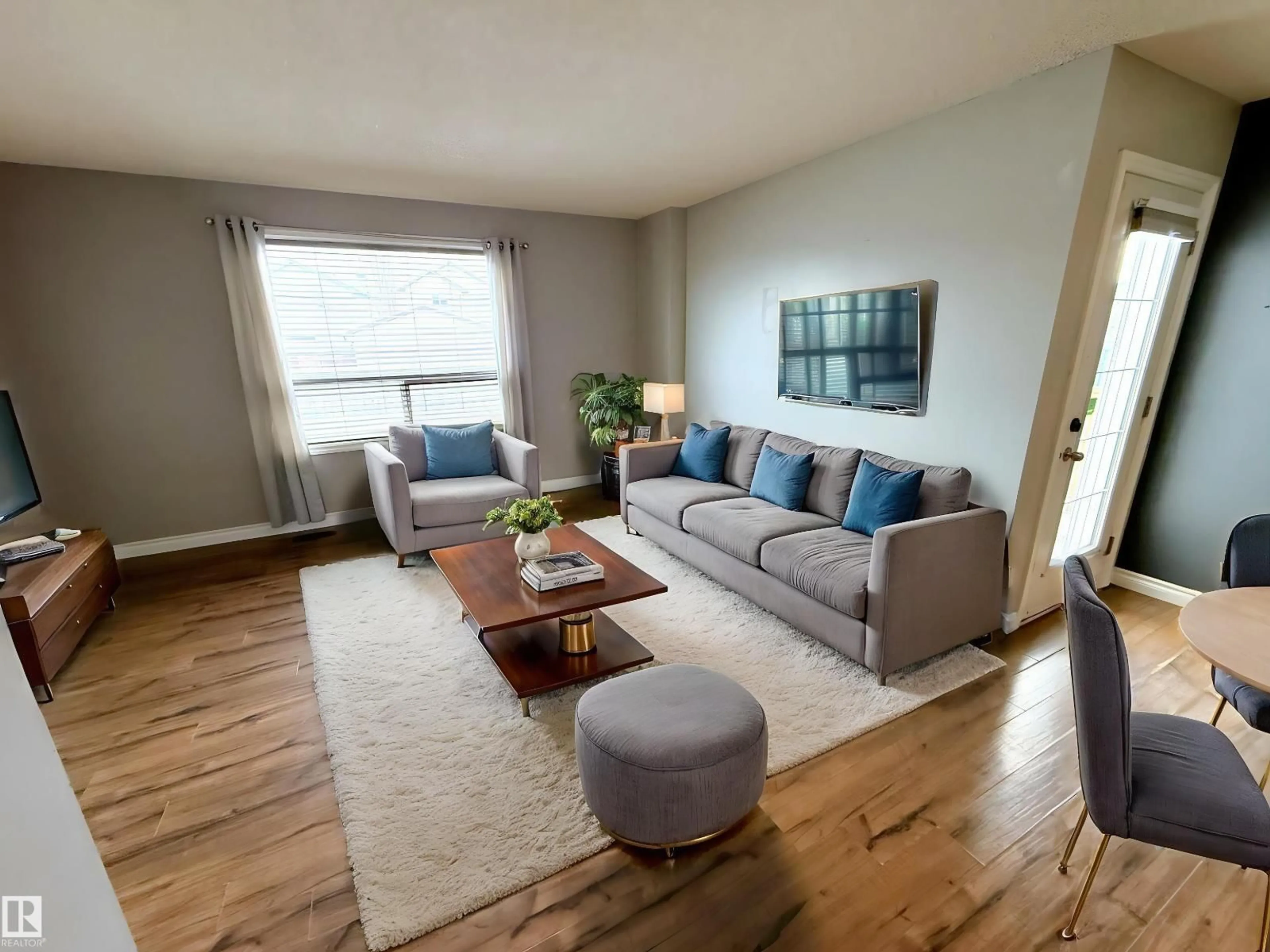 Living room with furniture, wood/laminate floor for 14005 158A AV, Edmonton Alberta T6V1V7