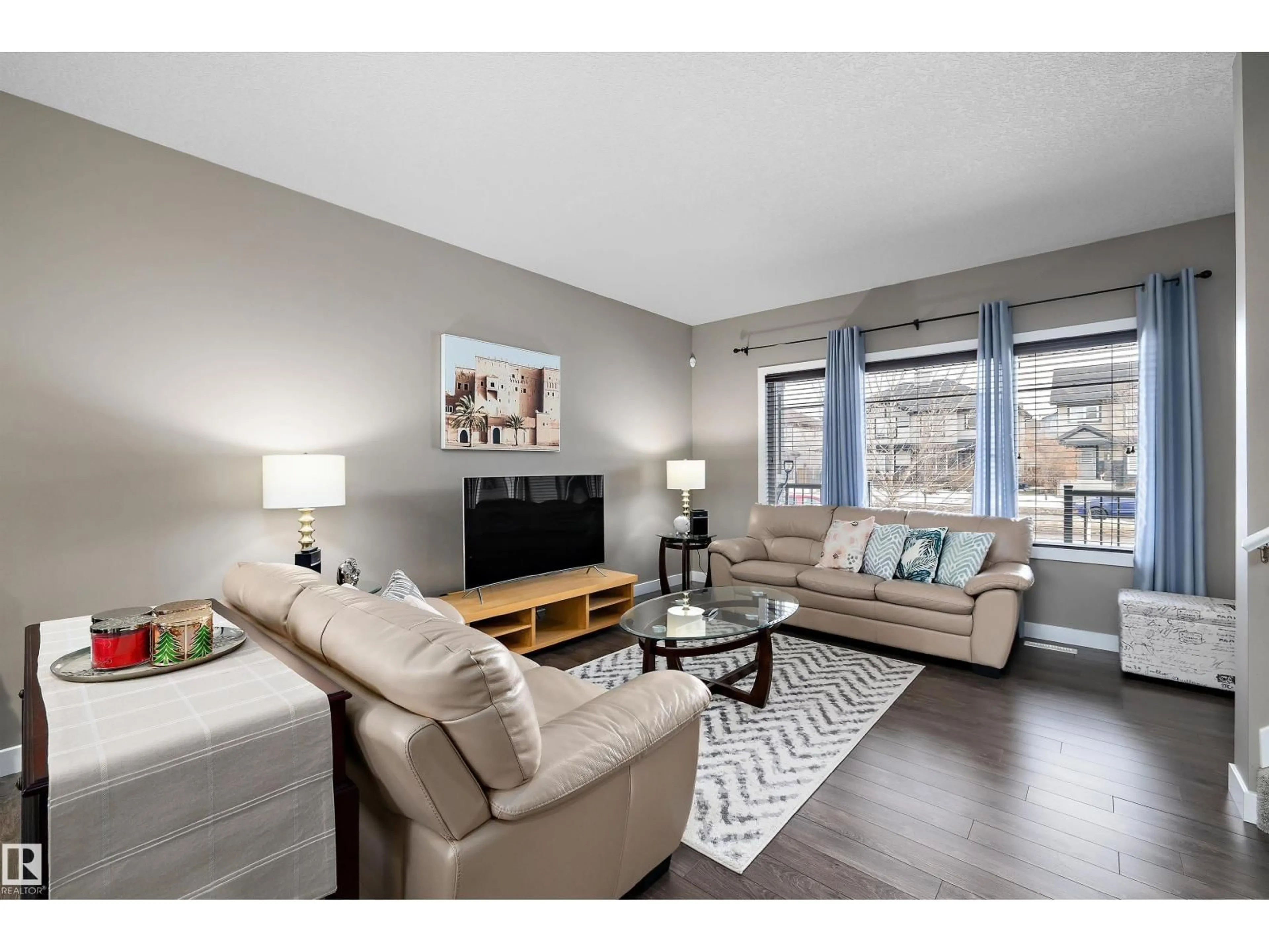 Living room with furniture, wood/laminate floor for 1074 WATT PROMENADE, Edmonton Alberta T6X1T7
