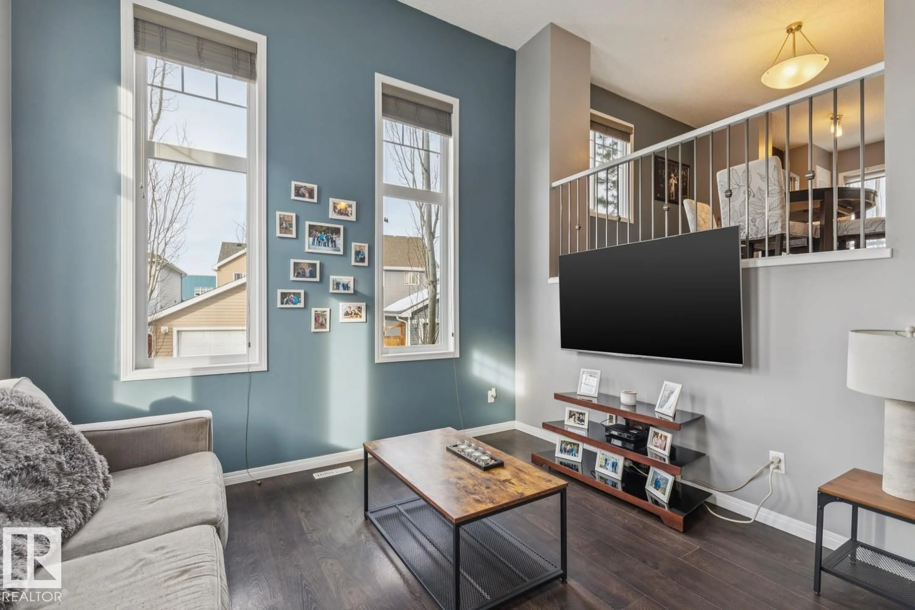 Living room with furniture, wood/laminate floor for 4050 - 89 SAVARYN DR, Edmonton Alberta T6X1R8