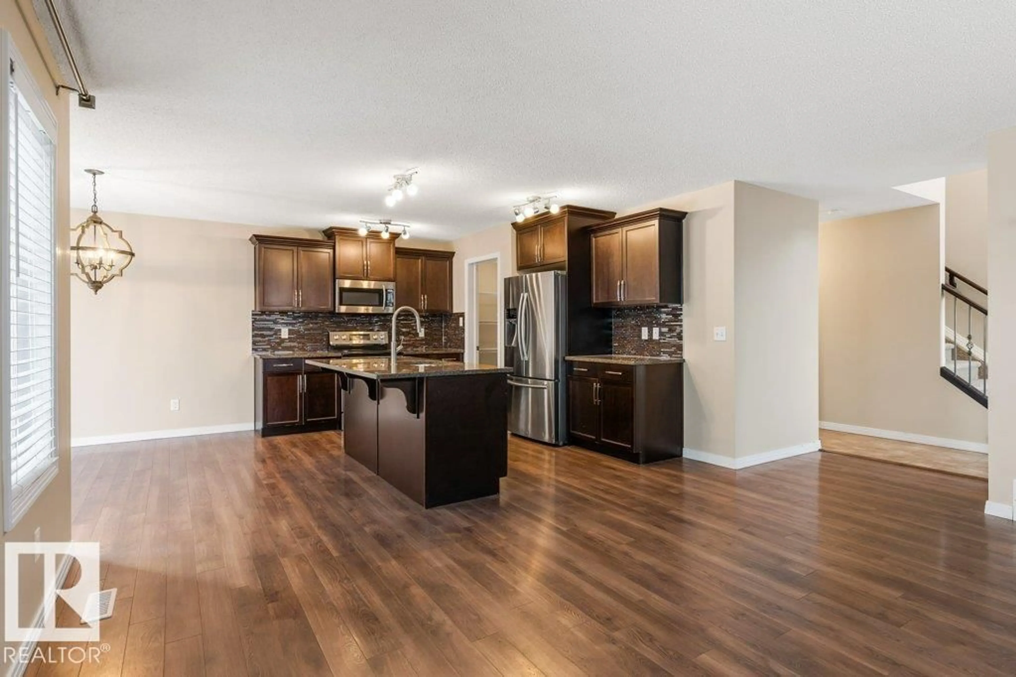 Open concept kitchen, wood/laminate floor for 7803 173 AV, Edmonton Alberta T5Z0H6
