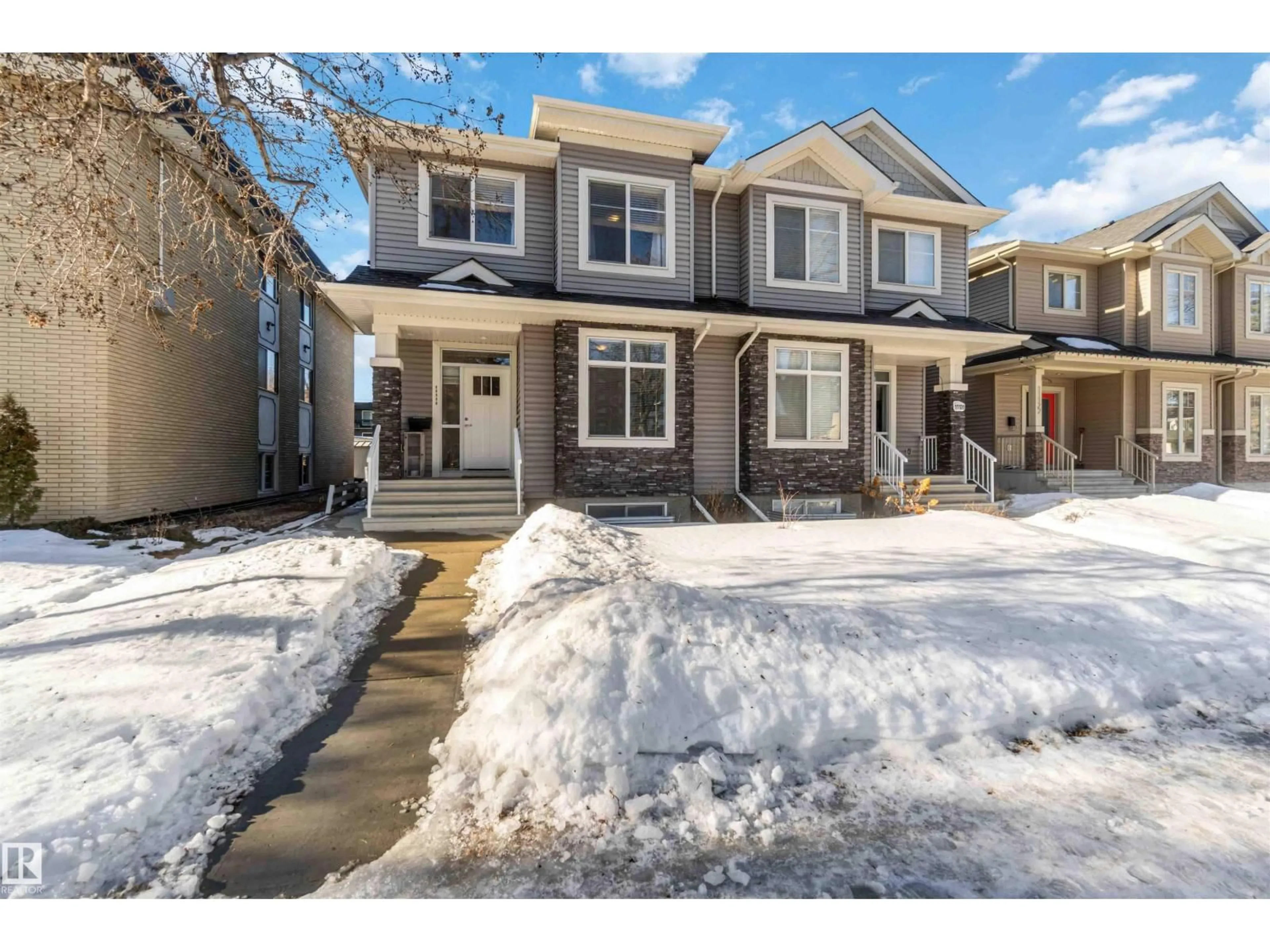 Home with vinyl exterior material, street for 11118 129 NW, Edmonton Alberta T5M0Y5