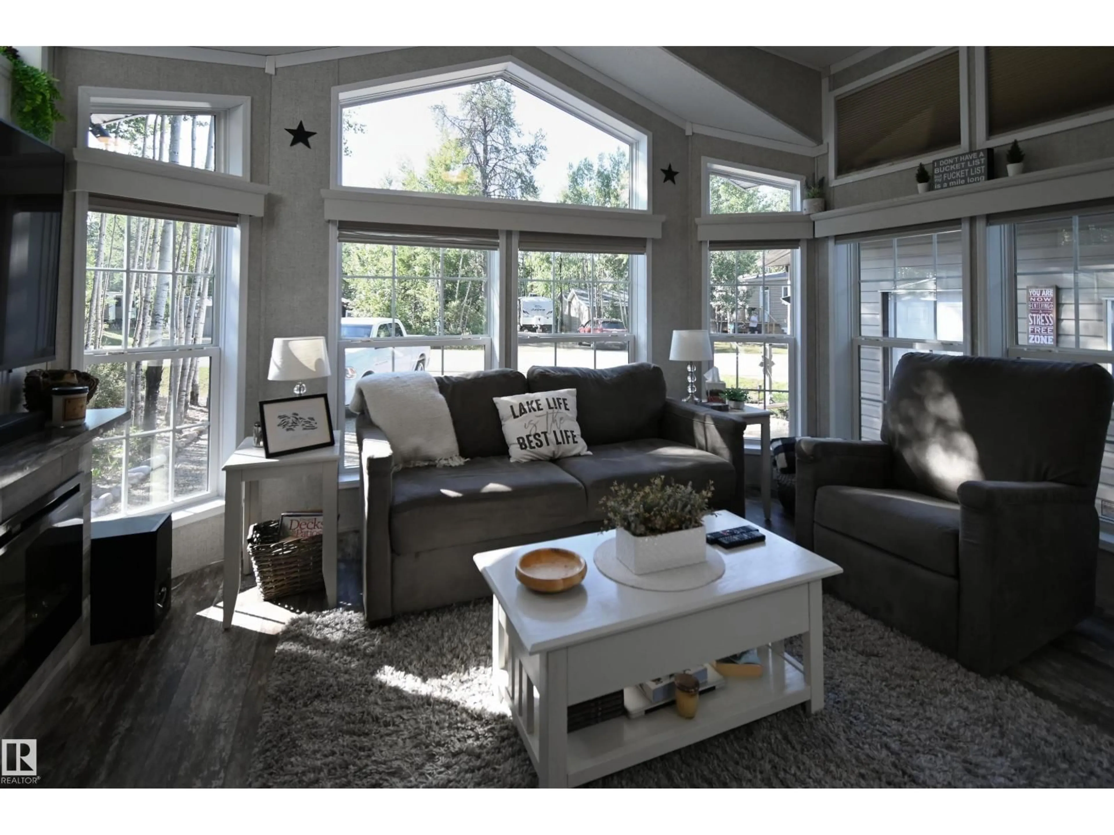 Living room with furniture, wood/laminate floor for 53206 - 64 RGE ROAD 55 A, Rural Parkland County Alberta T0E2B0