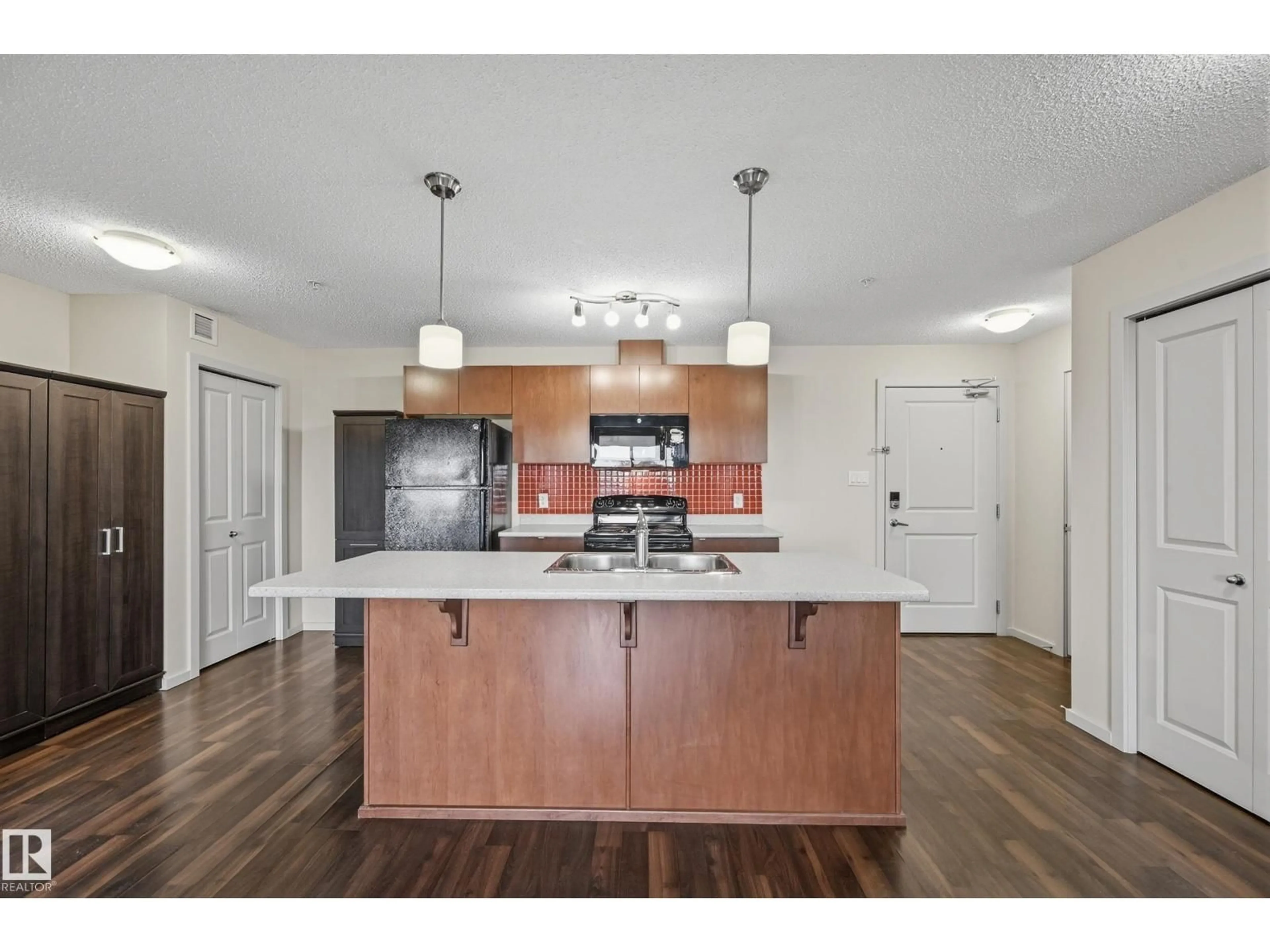 Open concept kitchen, wood/laminate floor for #309 - 508 ALBANY WY, Edmonton Alberta T6V0L1