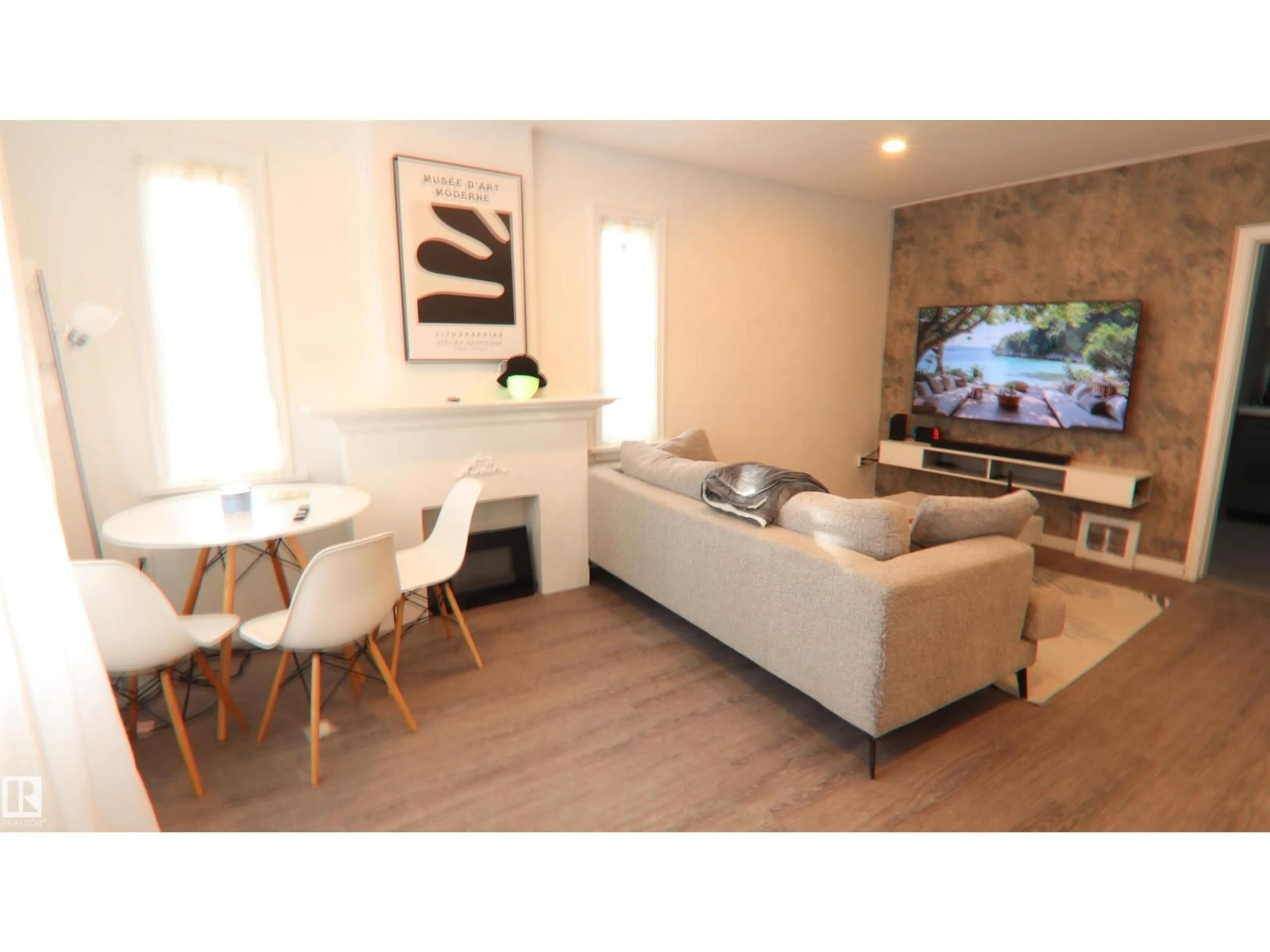 Living room with furniture, wood/laminate floor for 11161 67 ST, Edmonton Alberta T5B1K7