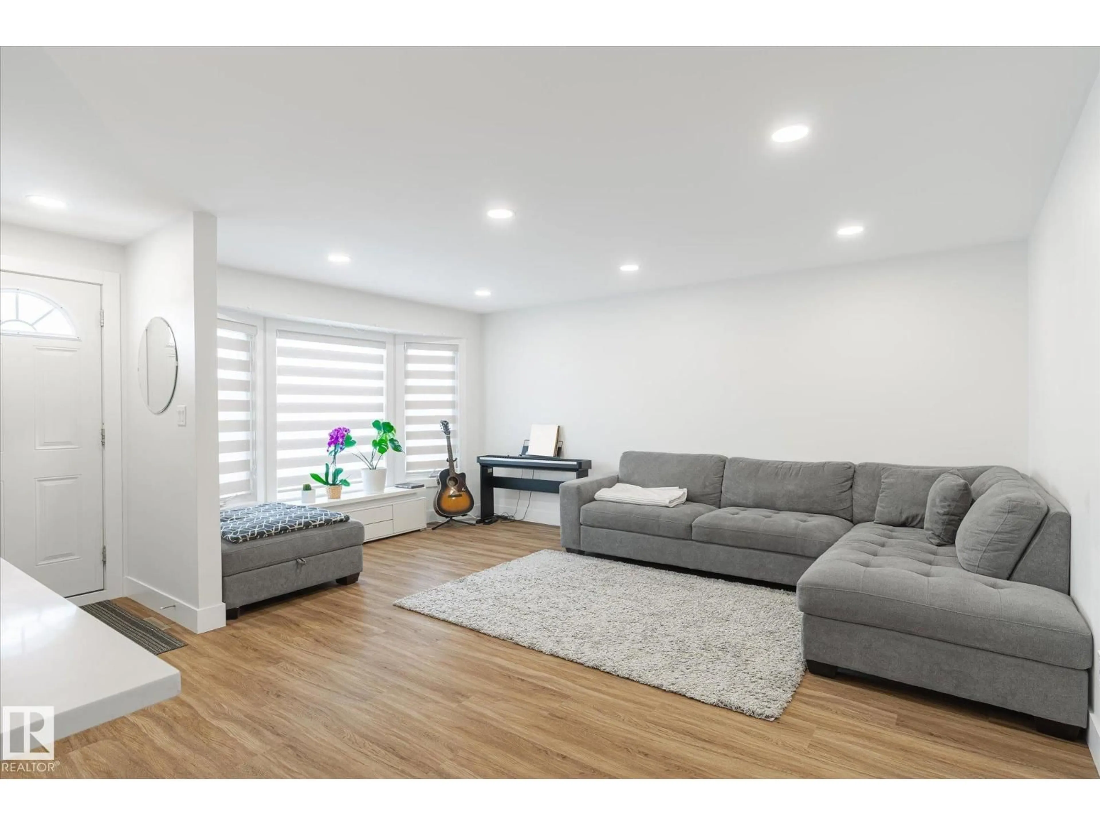 Living room with furniture, wood/laminate floor for NW - 1720 35 ST, Edmonton Alberta T6L2P1