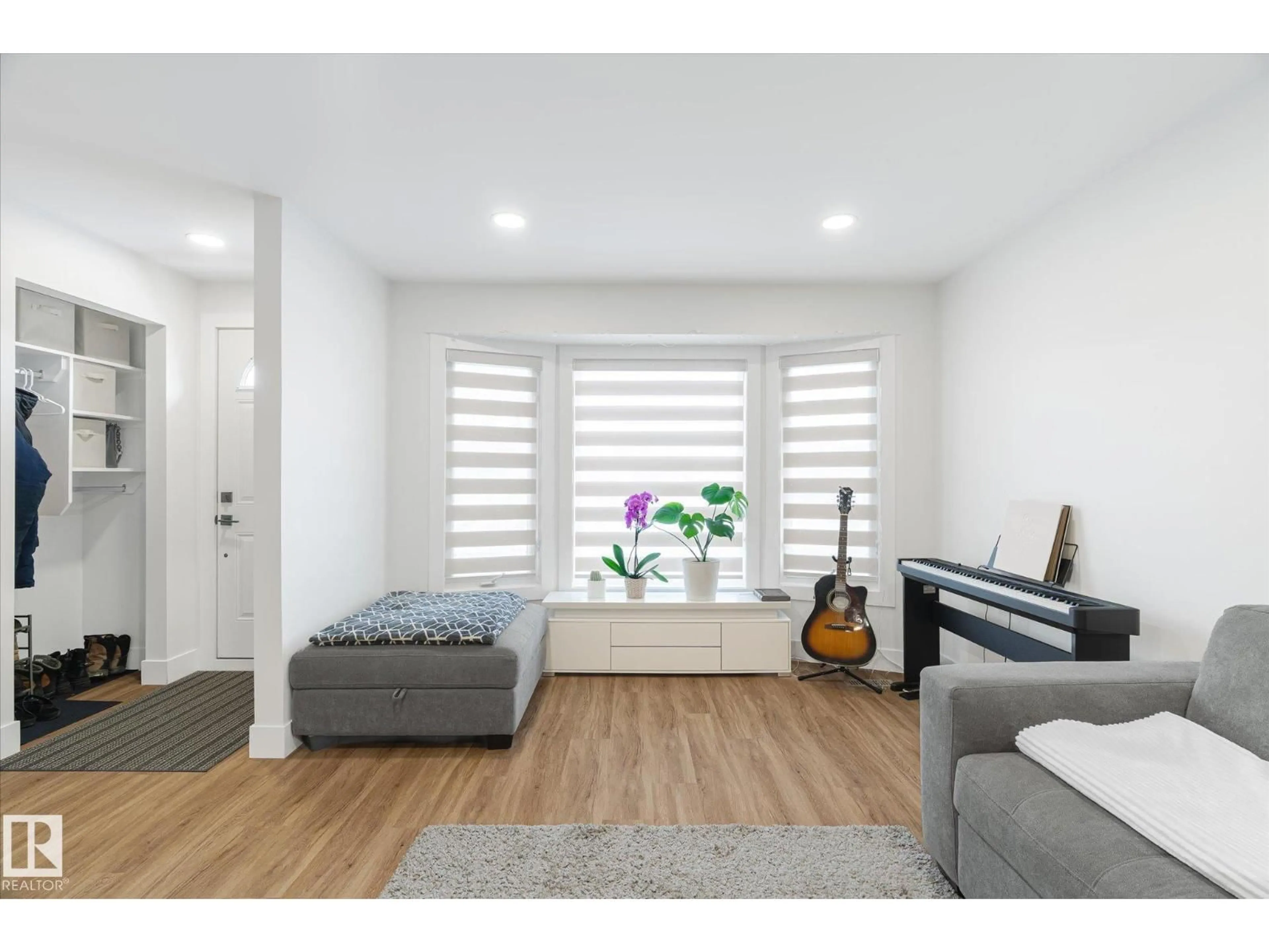 Living room with furniture, wood/laminate floor for NW - 1720 35 ST, Edmonton Alberta T6L2P1