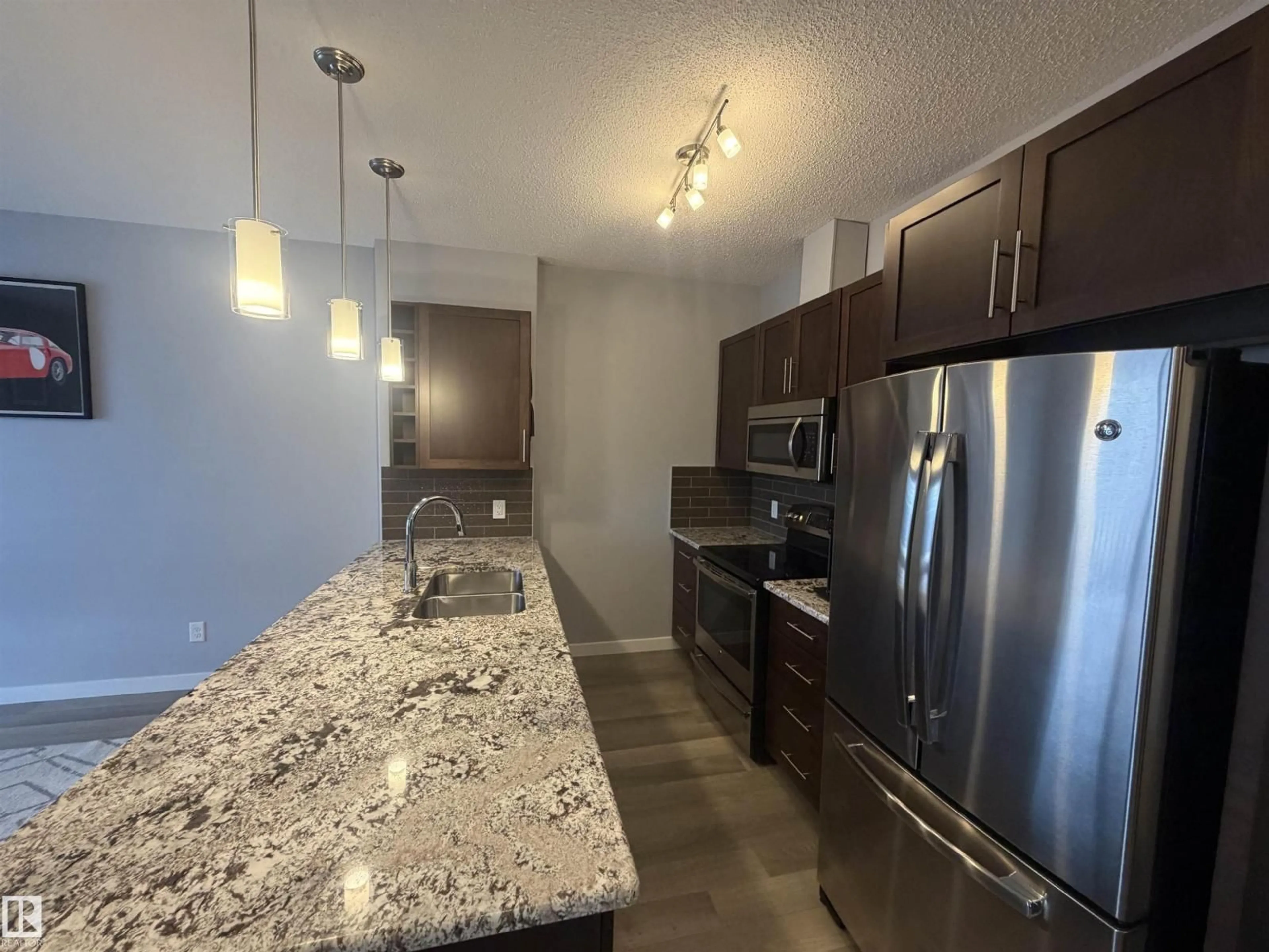 Open concept kitchen, unknown for 417 - 1004 ROSENTHAL BV, Edmonton Alberta T5T7C6