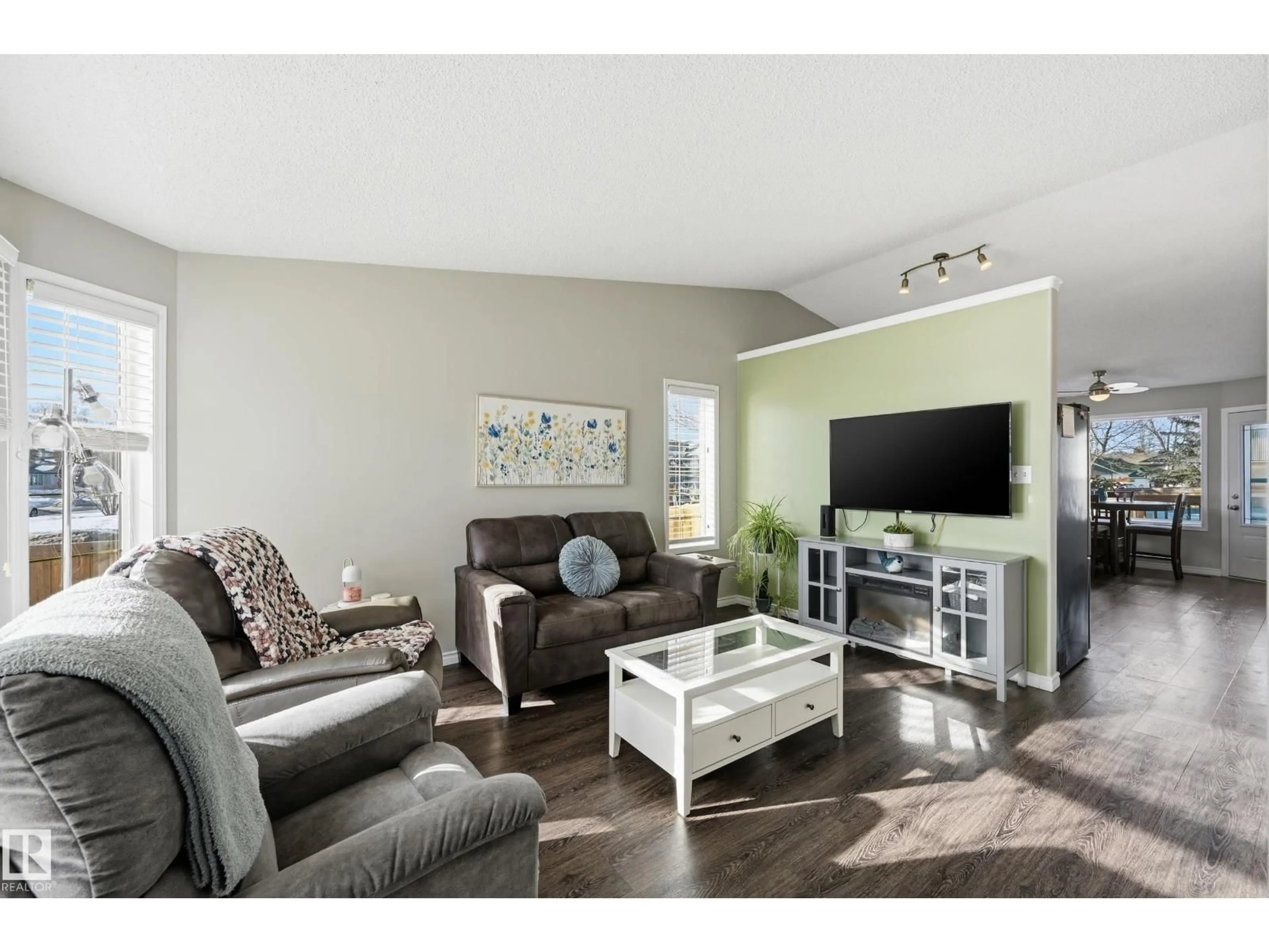 Living room with furniture, wood/laminate floor for NW - 2952 39 AV, Edmonton Alberta T6T1L2