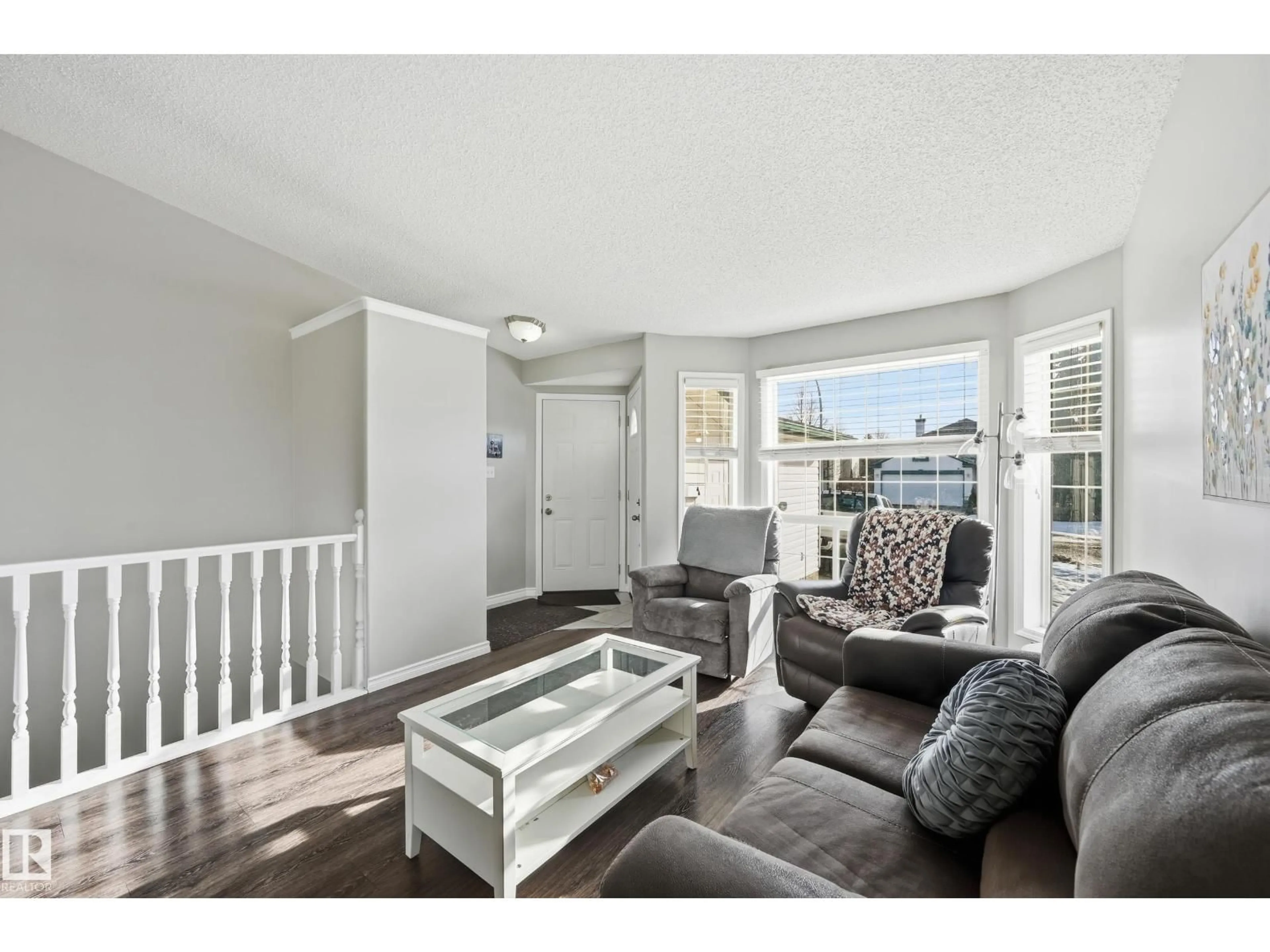 Living room with furniture, wood/laminate floor for NW - 2952 39 AV, Edmonton Alberta T6T1L2