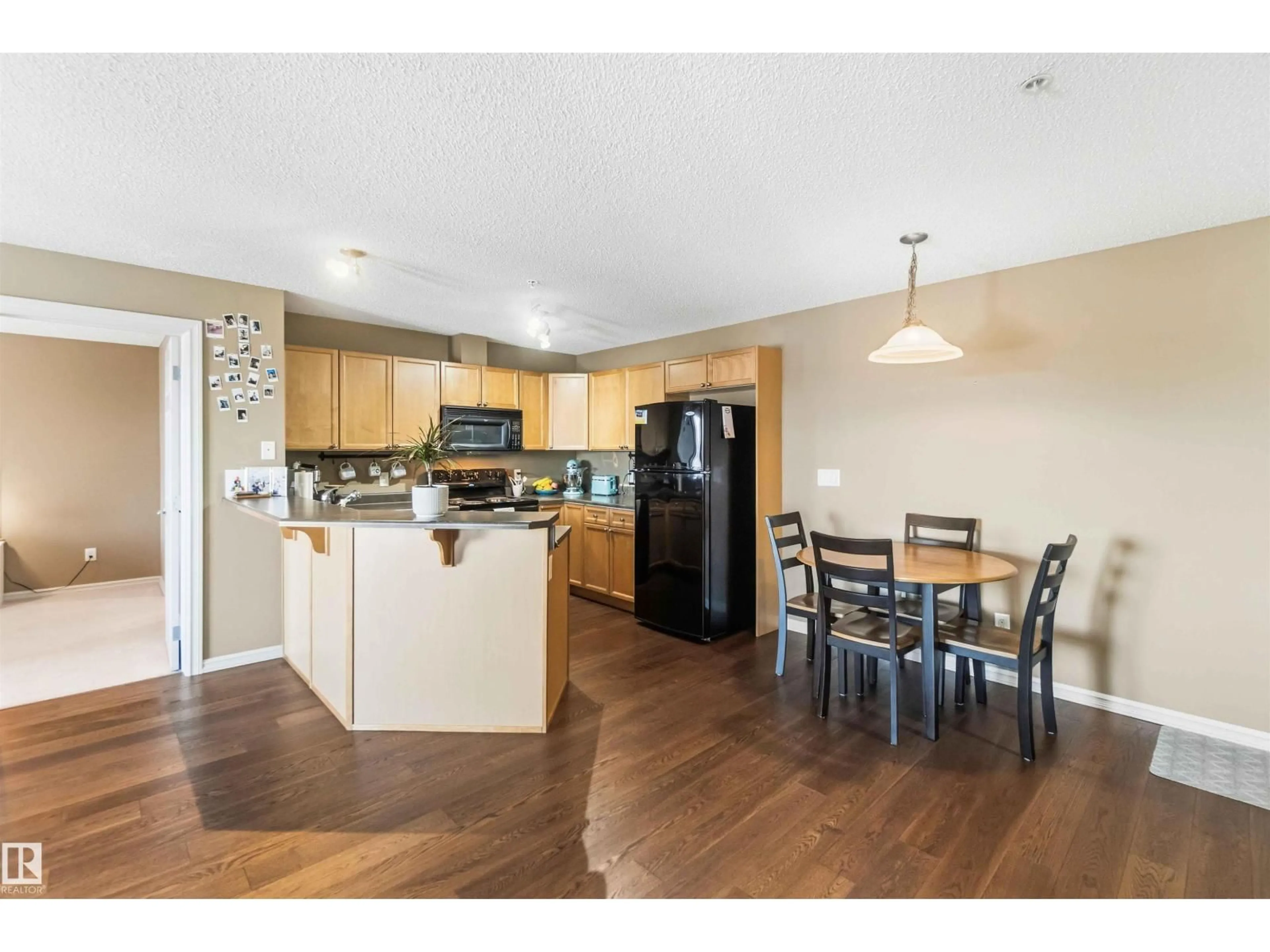 Open concept kitchen, wood/laminate floor for #305 - 13710 150 AV, Edmonton Alberta T6V0B2