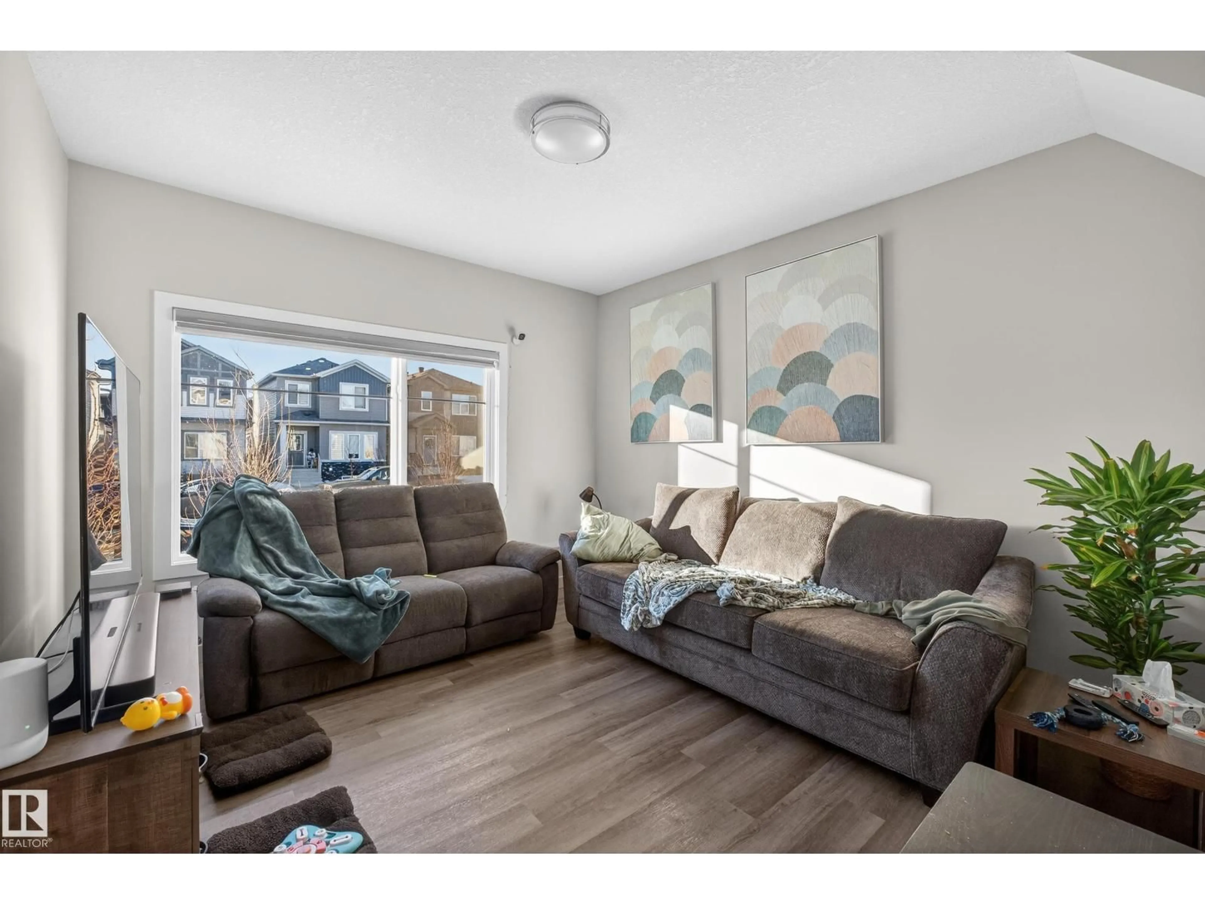 Living room with furniture, wood/laminate floor for 401 BLACK STONE LI, Leduc Alberta T9E1L8