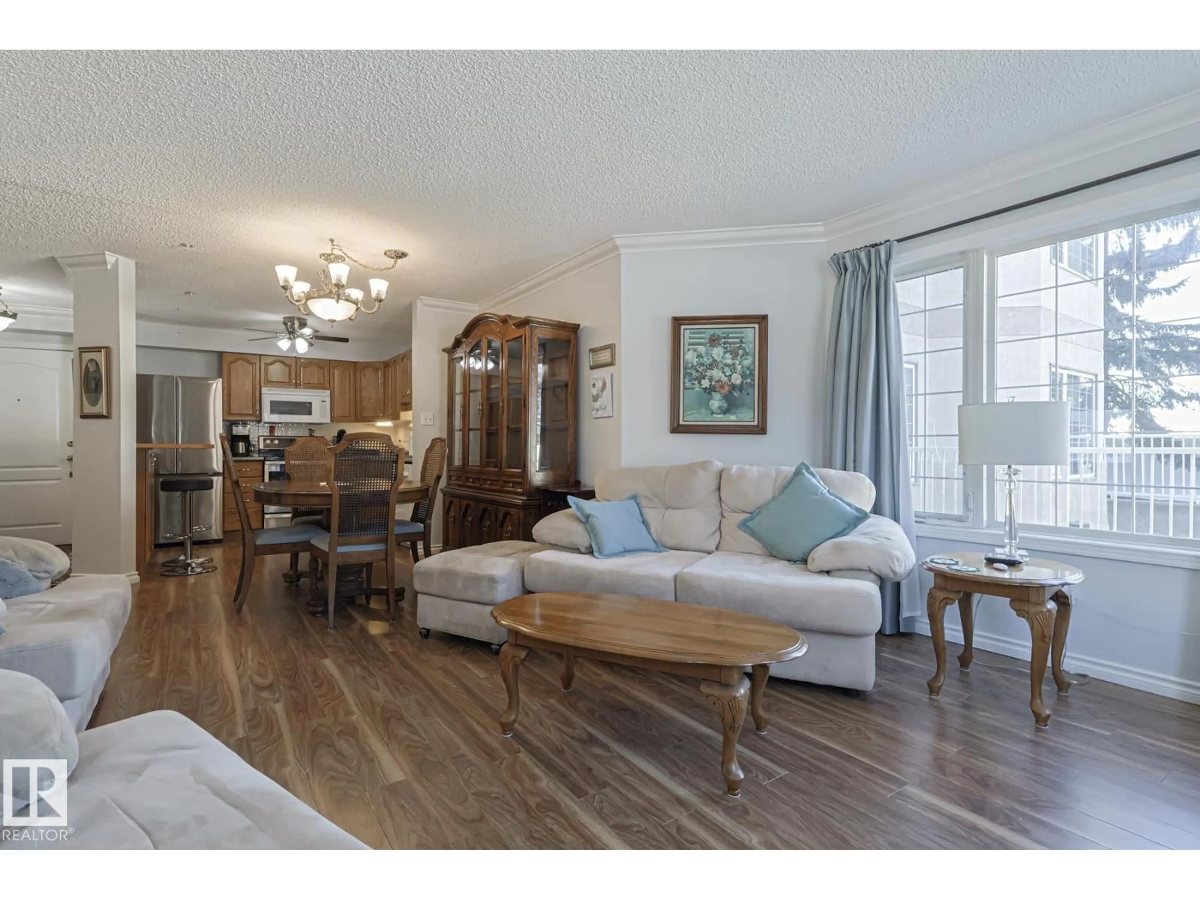 Living room with furniture, wood/laminate floor for #112 - 17150 94A AV, Edmonton Alberta T5T6L7