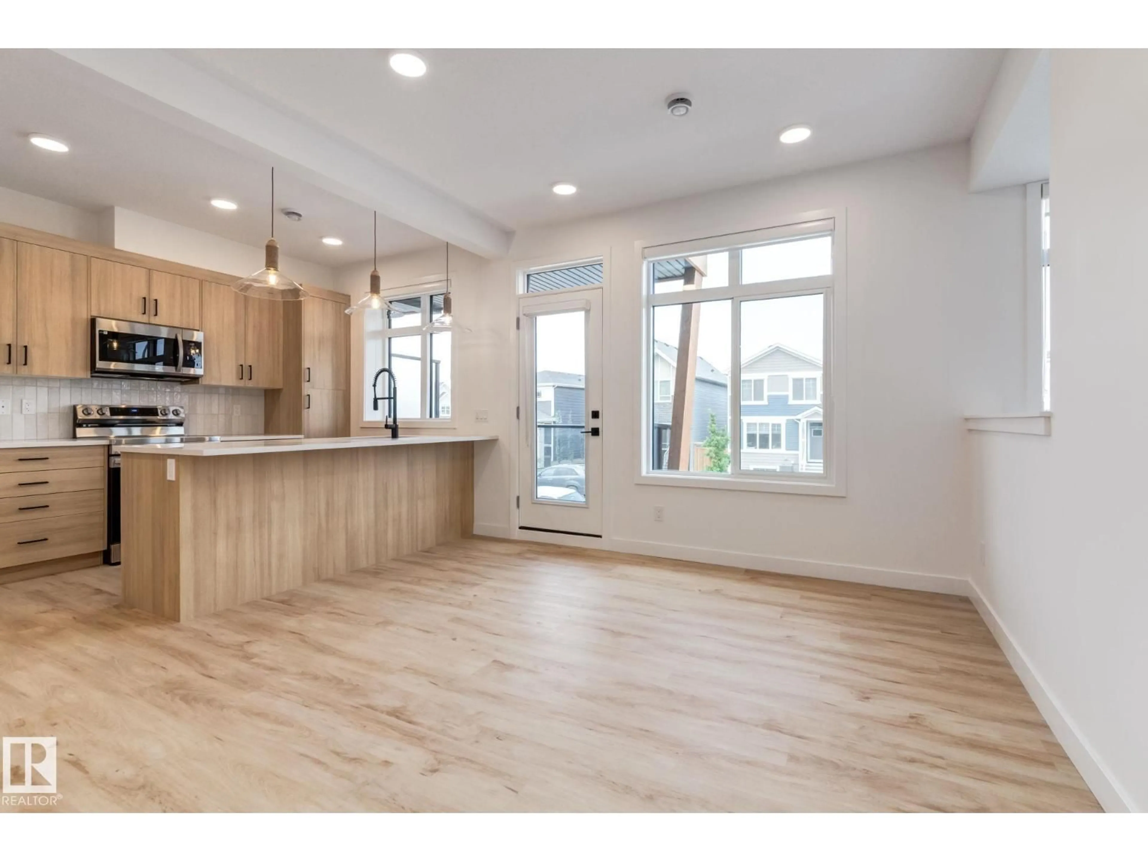 Open concept kitchen, wood/laminate floor for 17 - 16231 19 AV SW, Edmonton Alberta T6W5C6