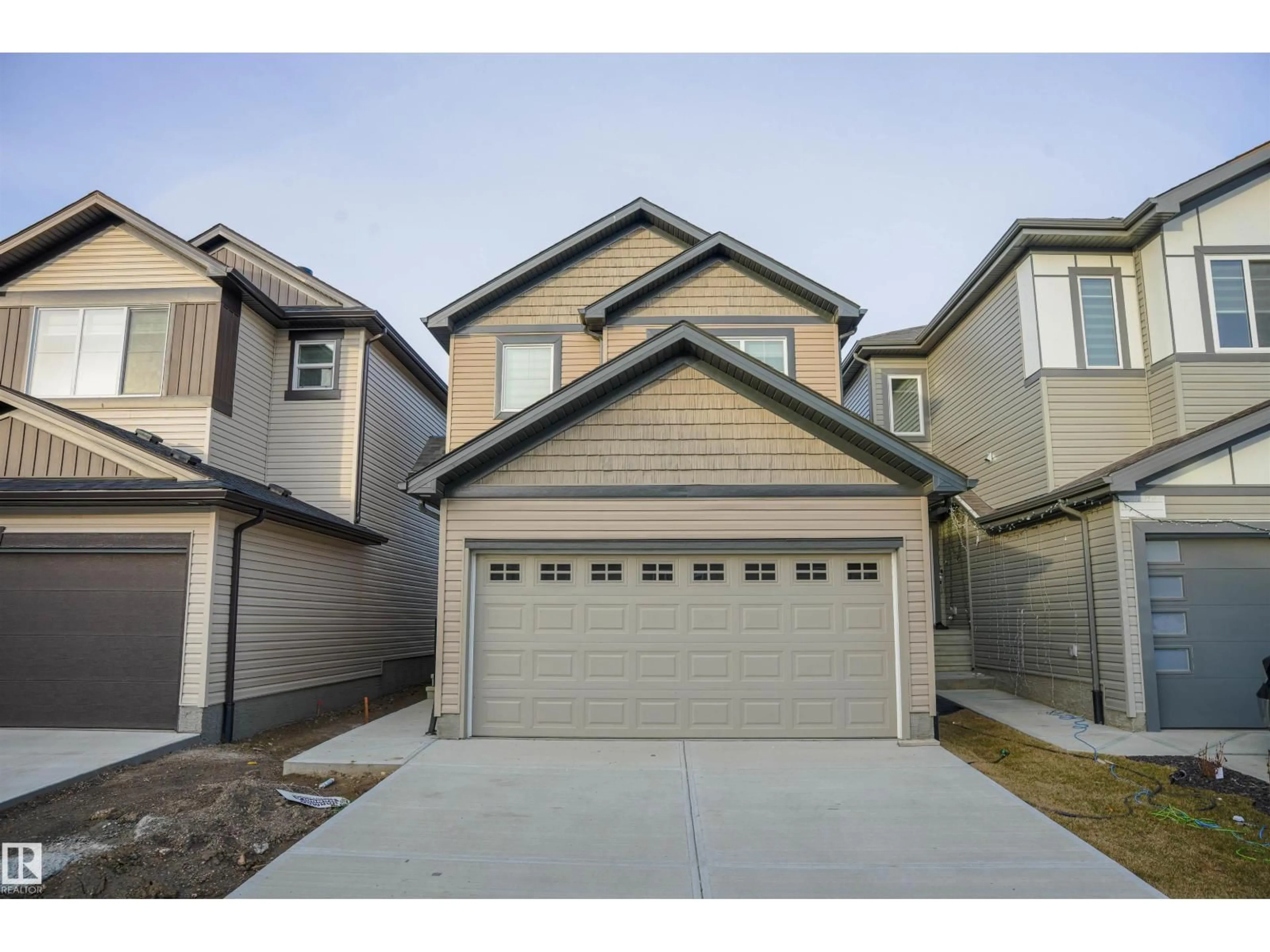 Home with vinyl exterior material, street for 1216 13 AV, Edmonton Alberta T6T2W2