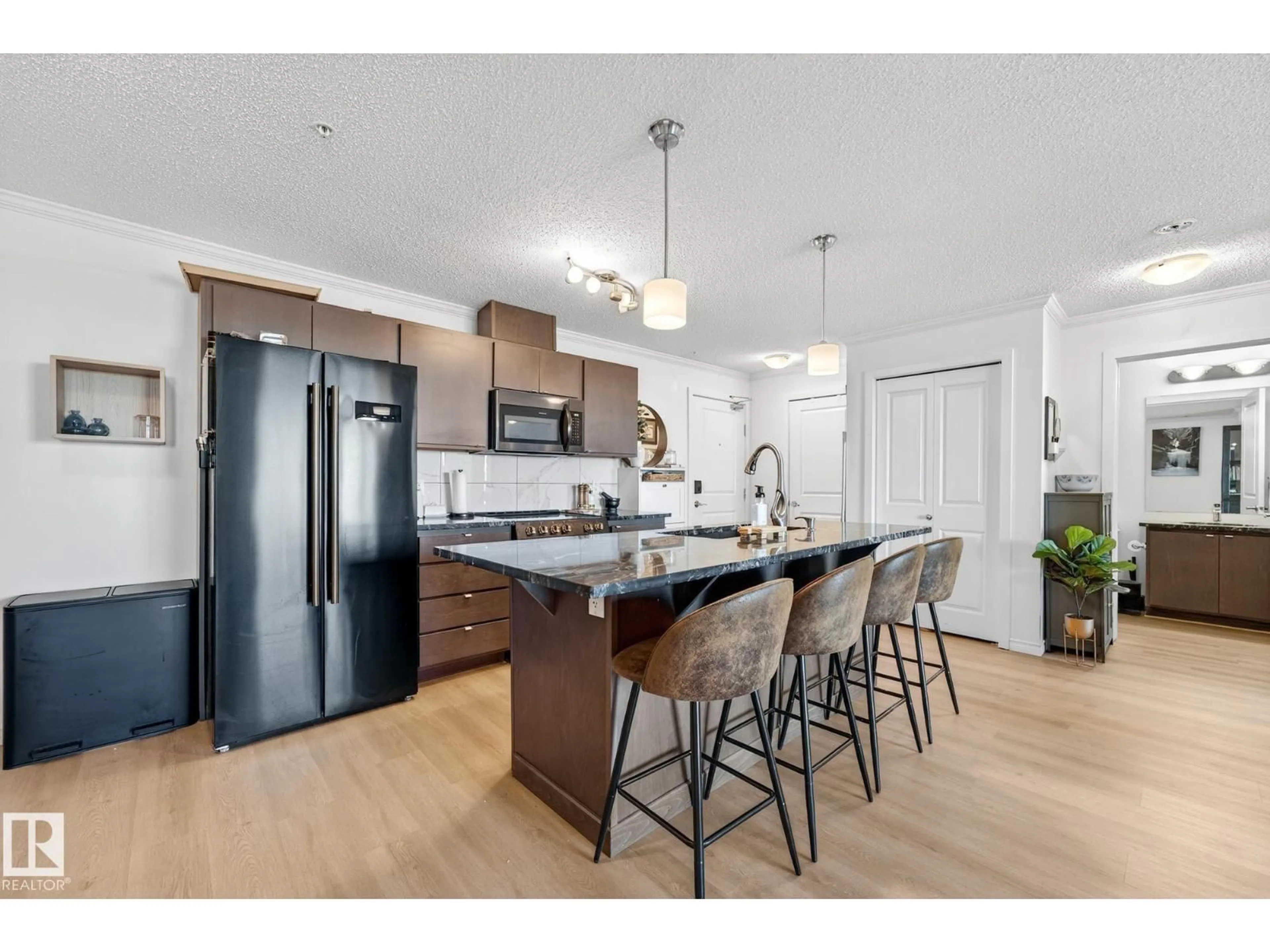 Open concept kitchen, wood/laminate floor for #357 - 1196 HYNDMAN RD, Edmonton Alberta T5A0X8