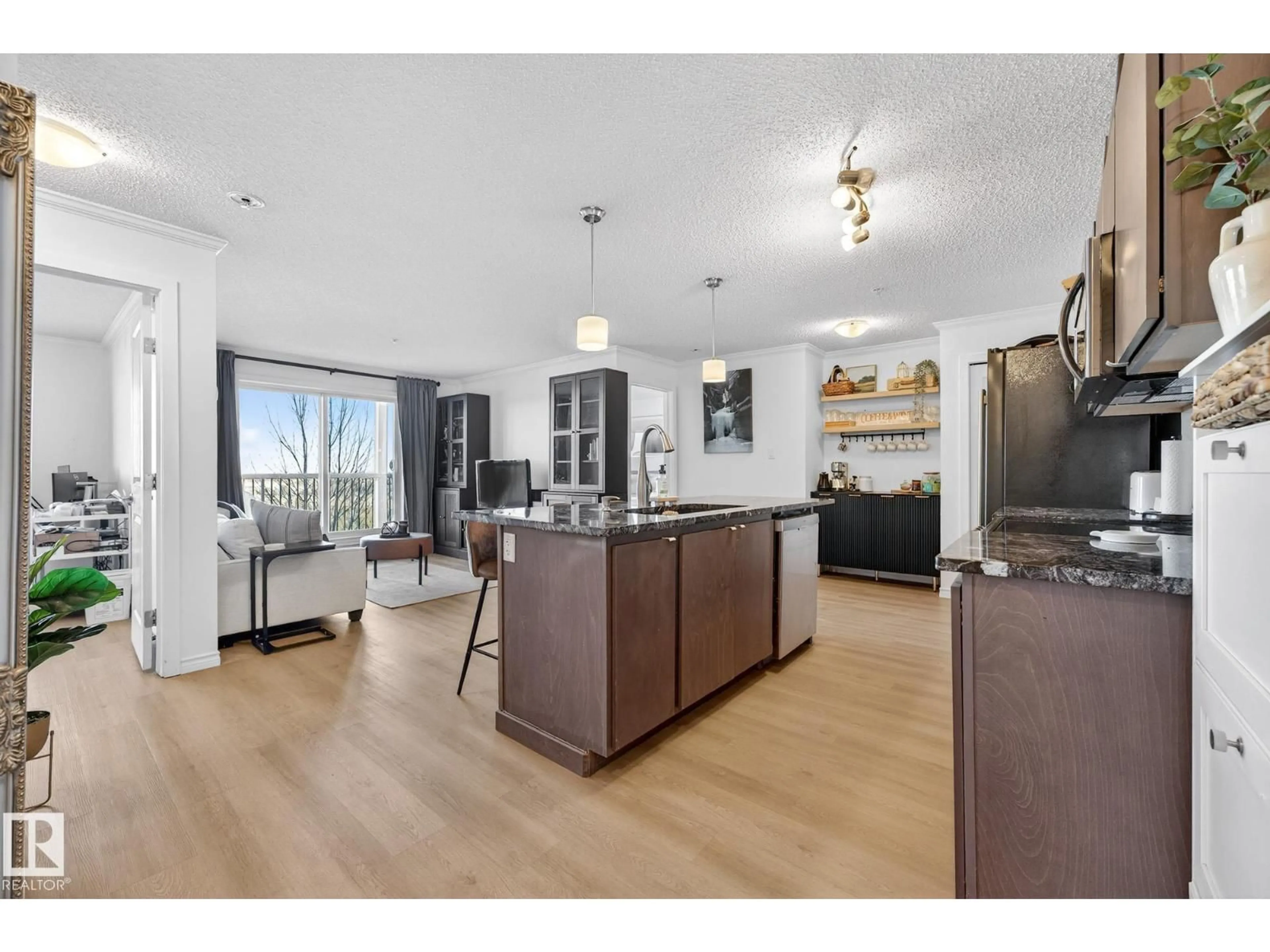 Open concept kitchen, wood/laminate floor for #357 - 1196 HYNDMAN RD, Edmonton Alberta T5A0X8