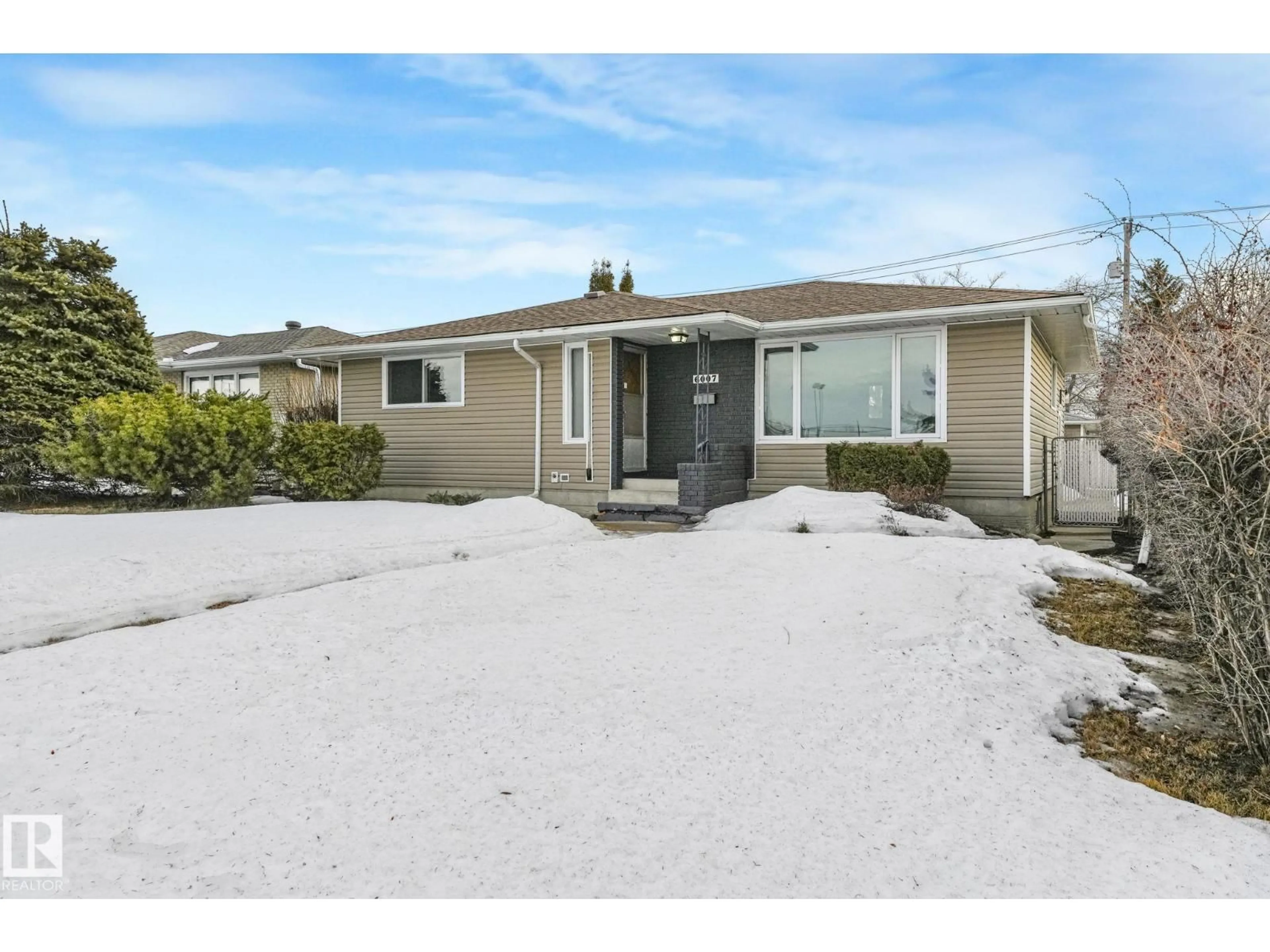 Home with vinyl exterior material, street for 6007 95 AV, Edmonton Alberta T6B1A4