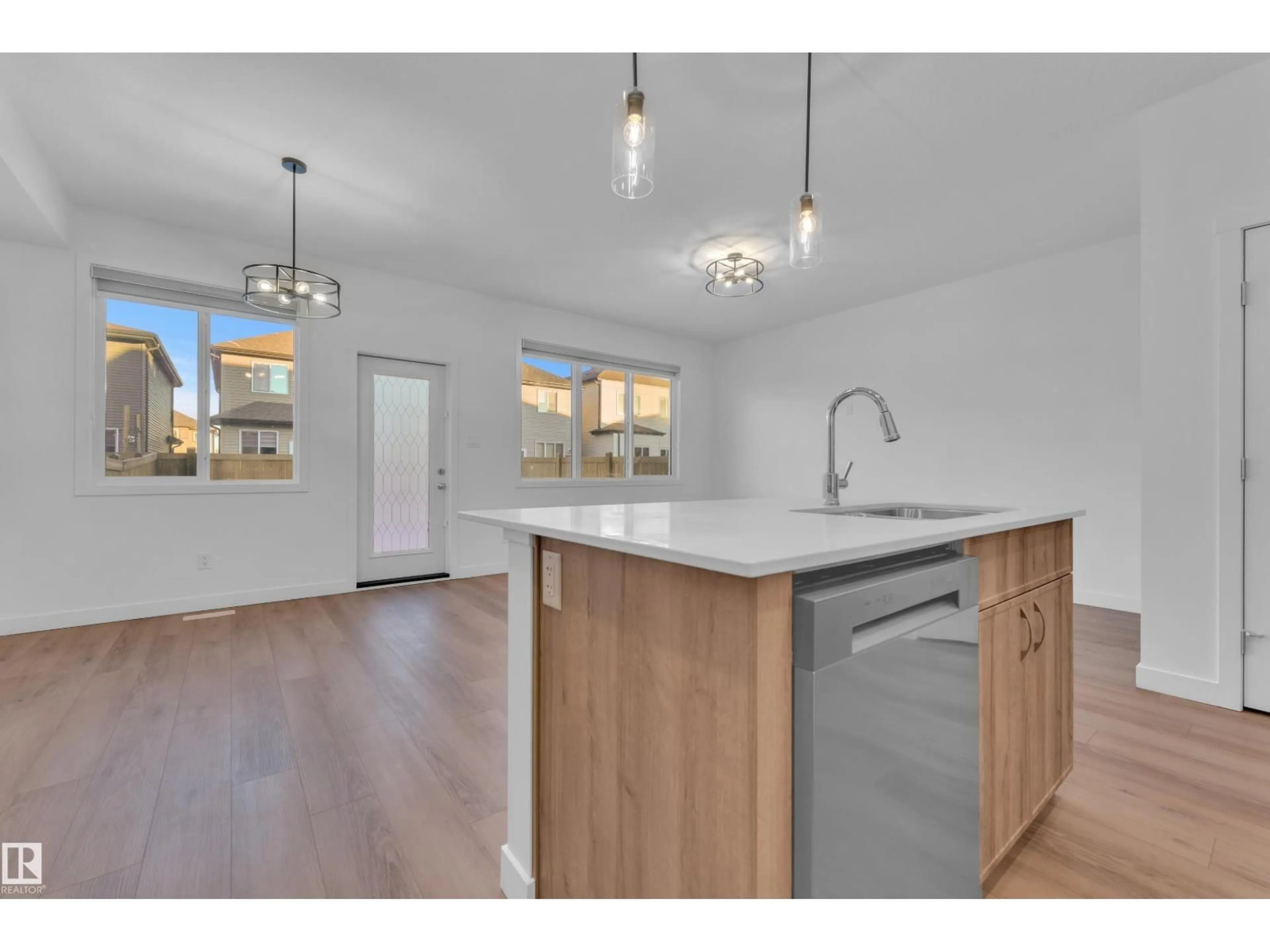 Open concept kitchen, wood/laminate floor for 1667 13 ST, Edmonton Alberta T6T2N5