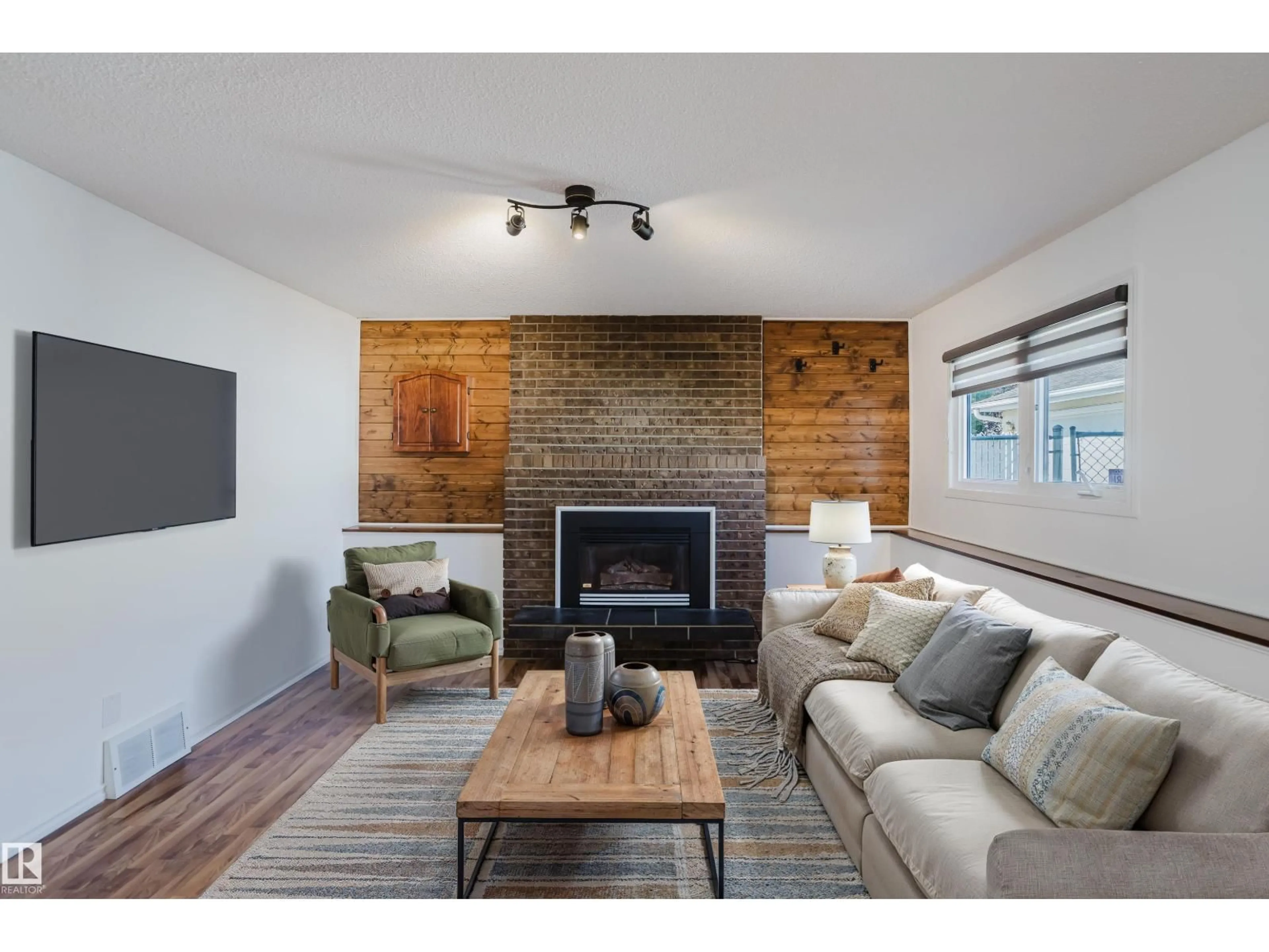 Living room with furniture, wood/laminate floor for 4102 43A AV, Leduc Alberta T9E6Z6
