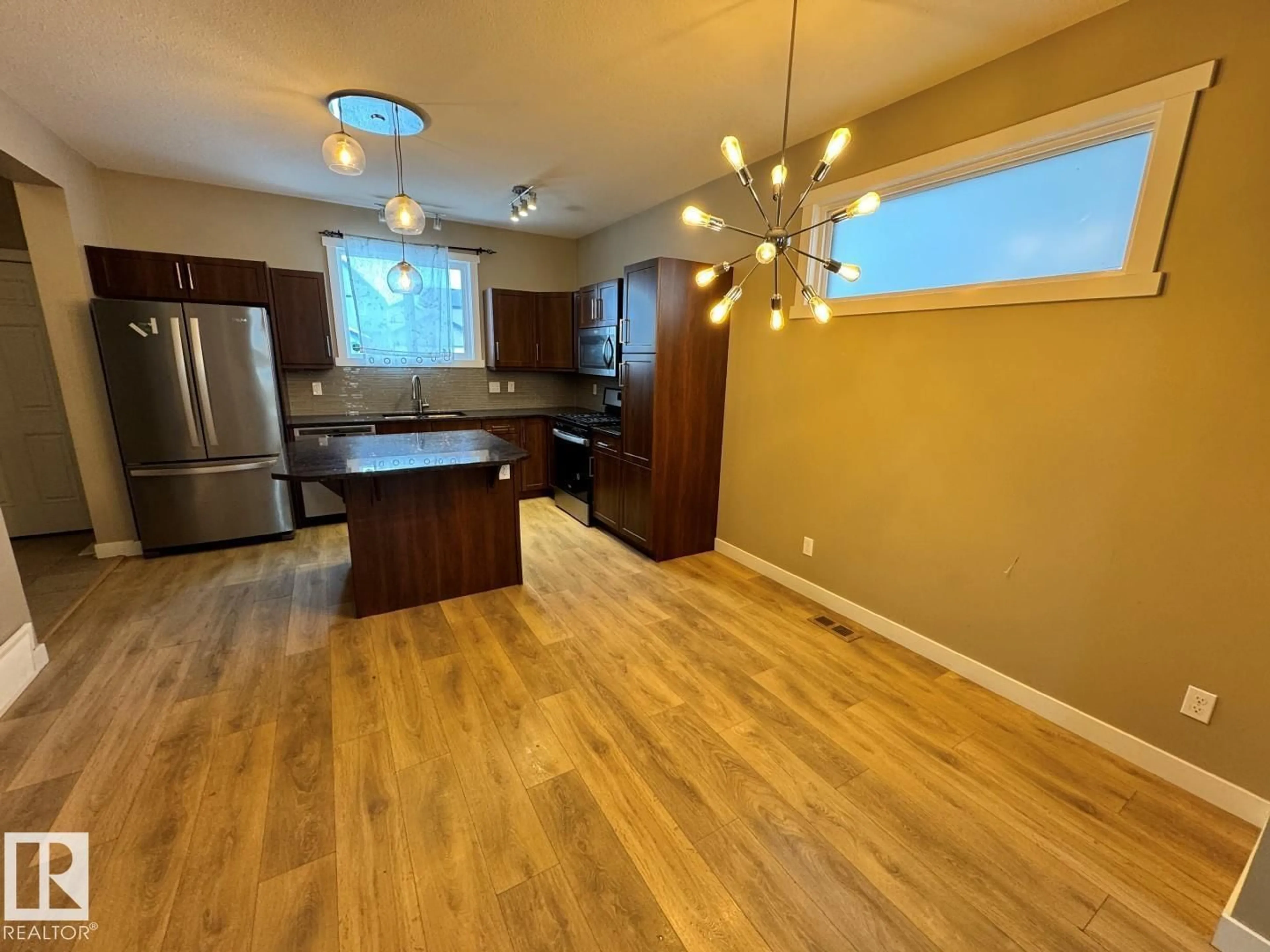 Open concept kitchen, wood/laminate floor for NW - 22724 97 AV, Edmonton Alberta T5T7J2