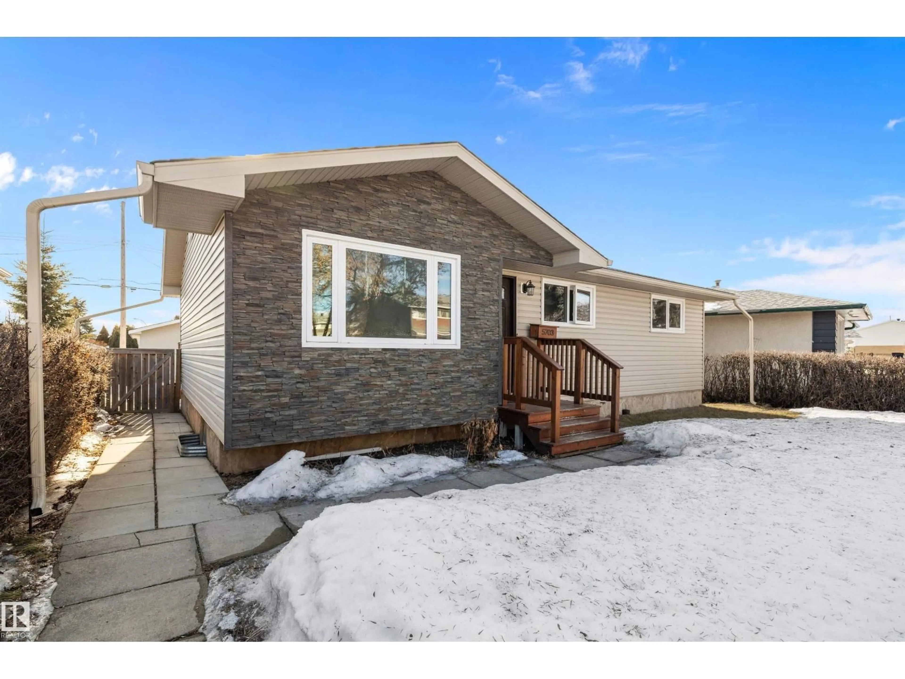Home with vinyl exterior material, street for 5703 143 AV, Edmonton Alberta T5A1J9
