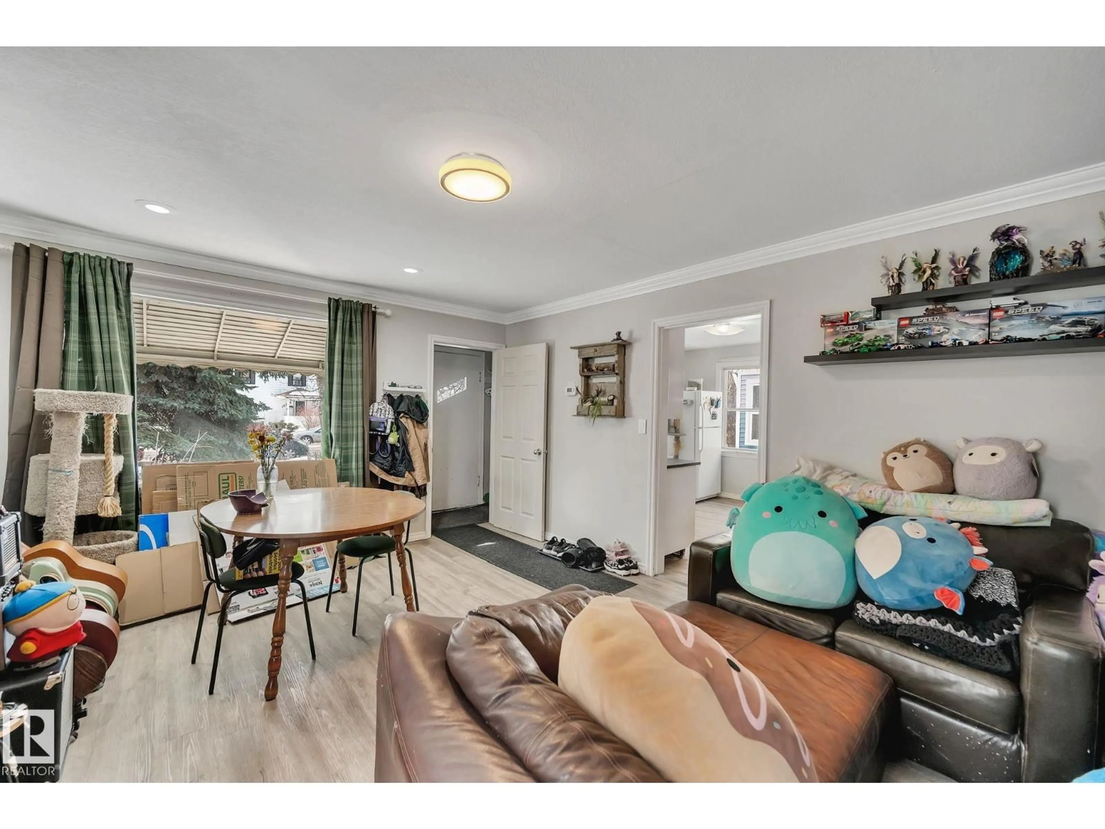 Living room with furniture, wood/laminate floor for NW - 12235 104 ST, Edmonton Alberta T5G2L7