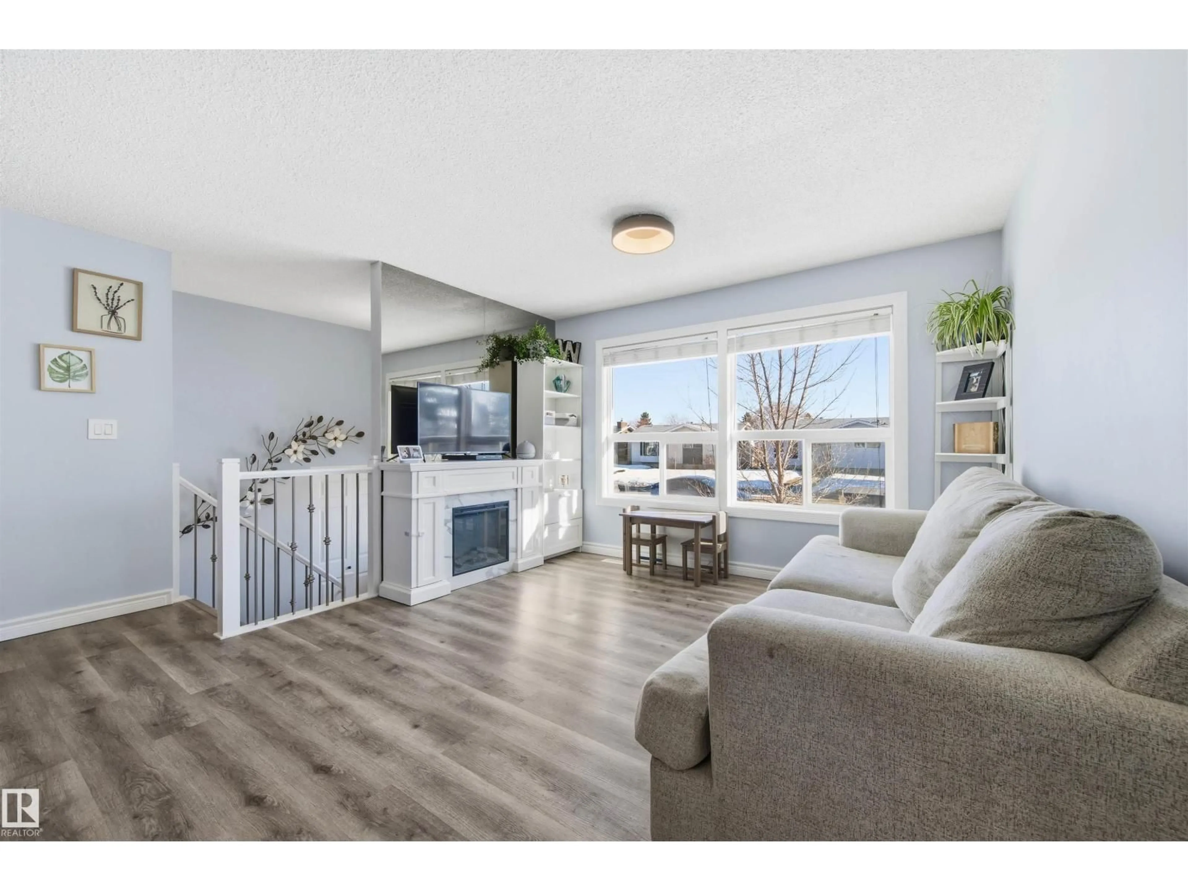 Living room with furniture, wood/laminate floor for 848 MILLBOURNE RD E, Edmonton Alberta T6K0S3